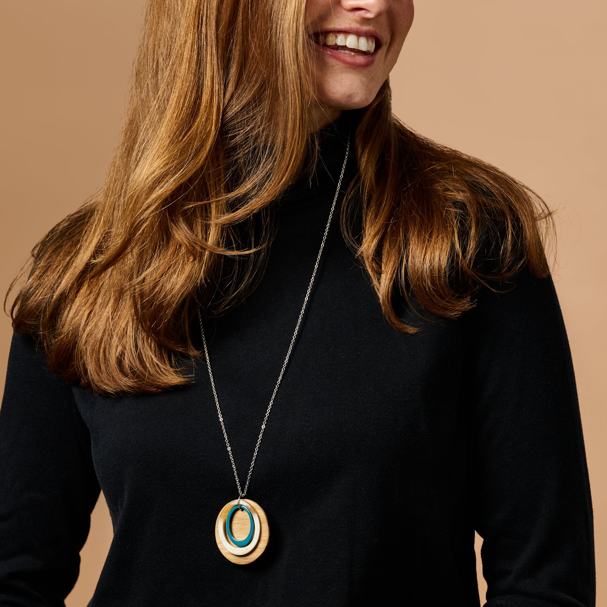 Close-up of the Harmony Wood and Horn Artisan Necklace showcasing its cream and brown tones.