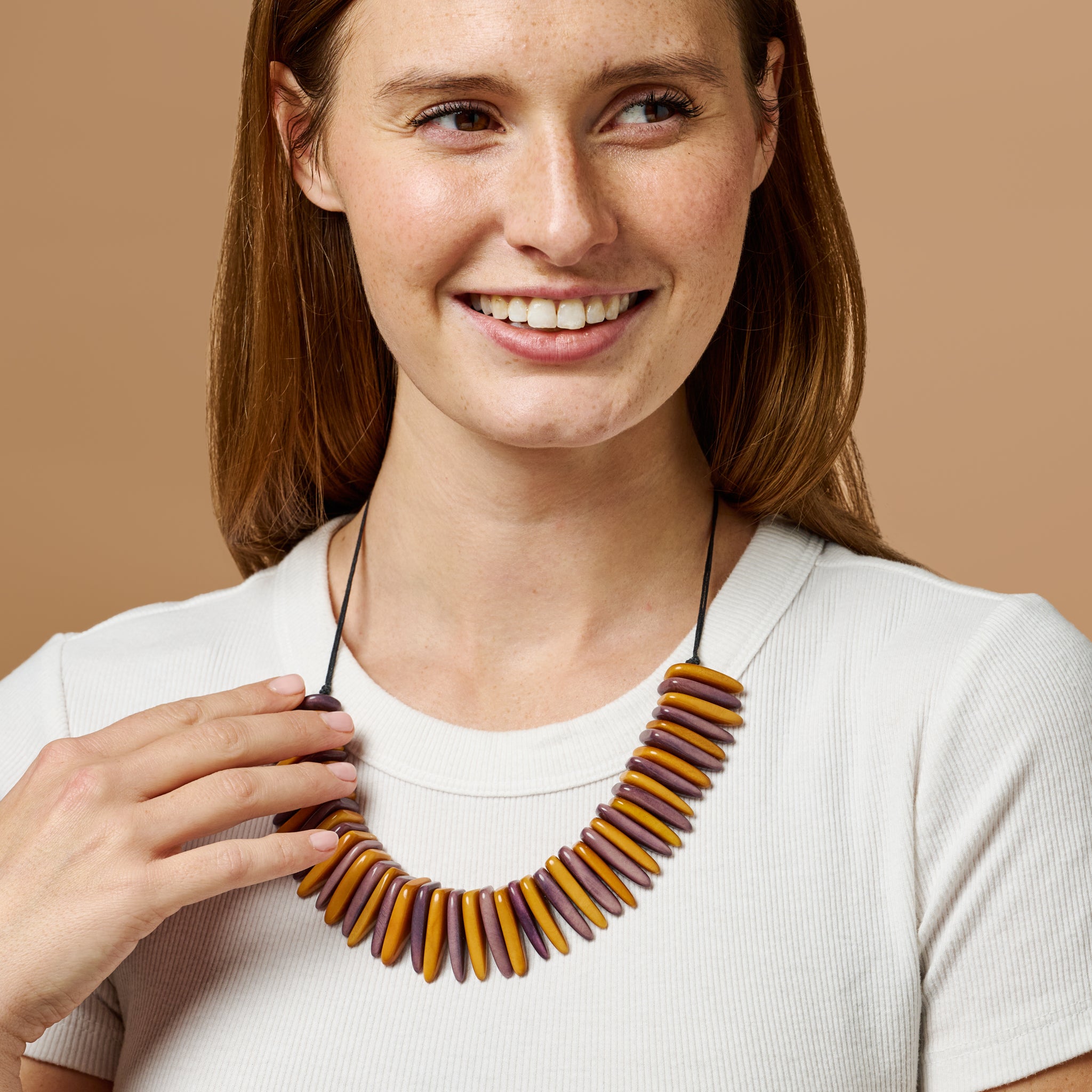 Close-up of the Tagua Slice Bib Necklace showing vibrant natural textures and eco-friendly craftsmanship