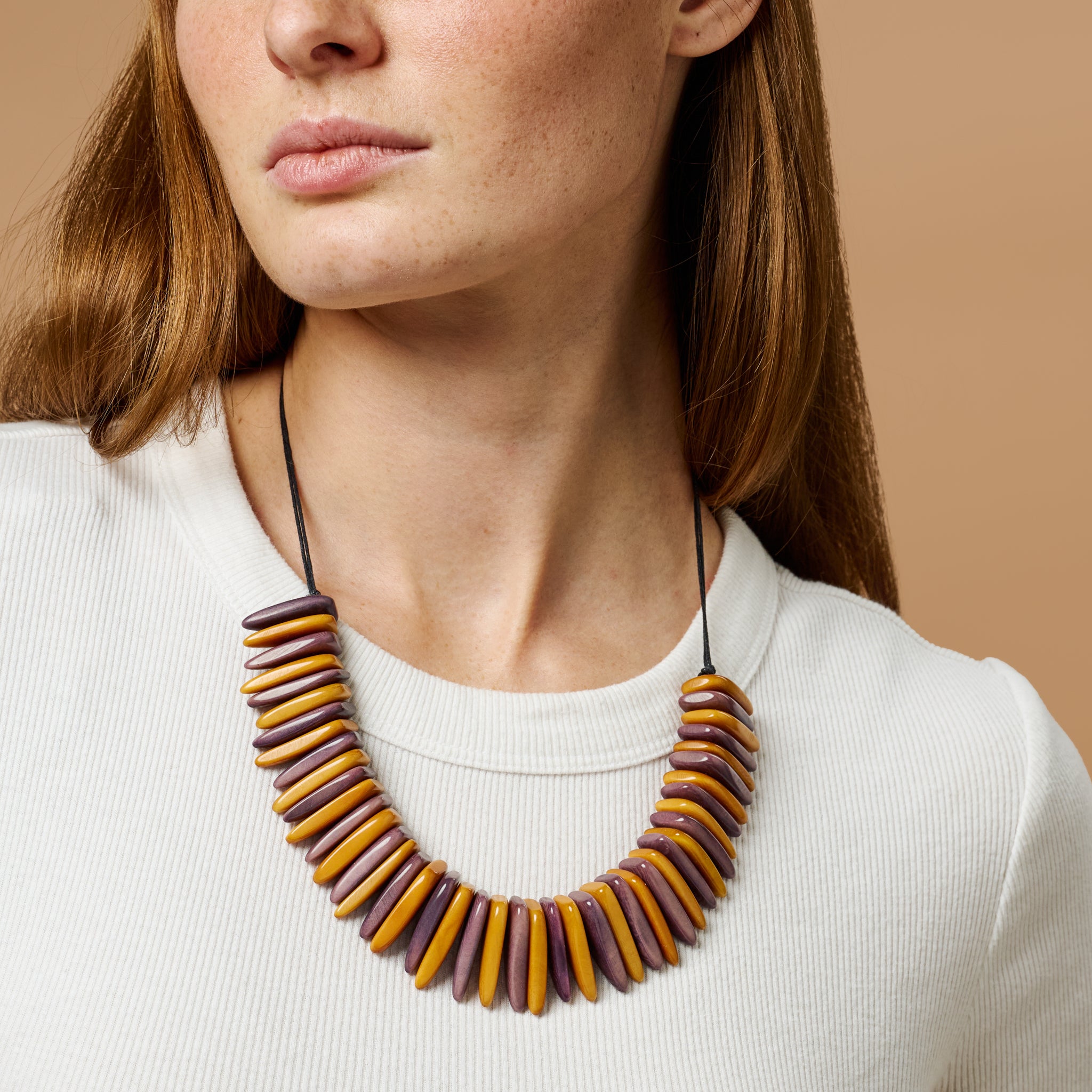 Close-up of the Tagua Slice Bib Necklace showing vibrant natural textures and eco-friendly craftsmanship