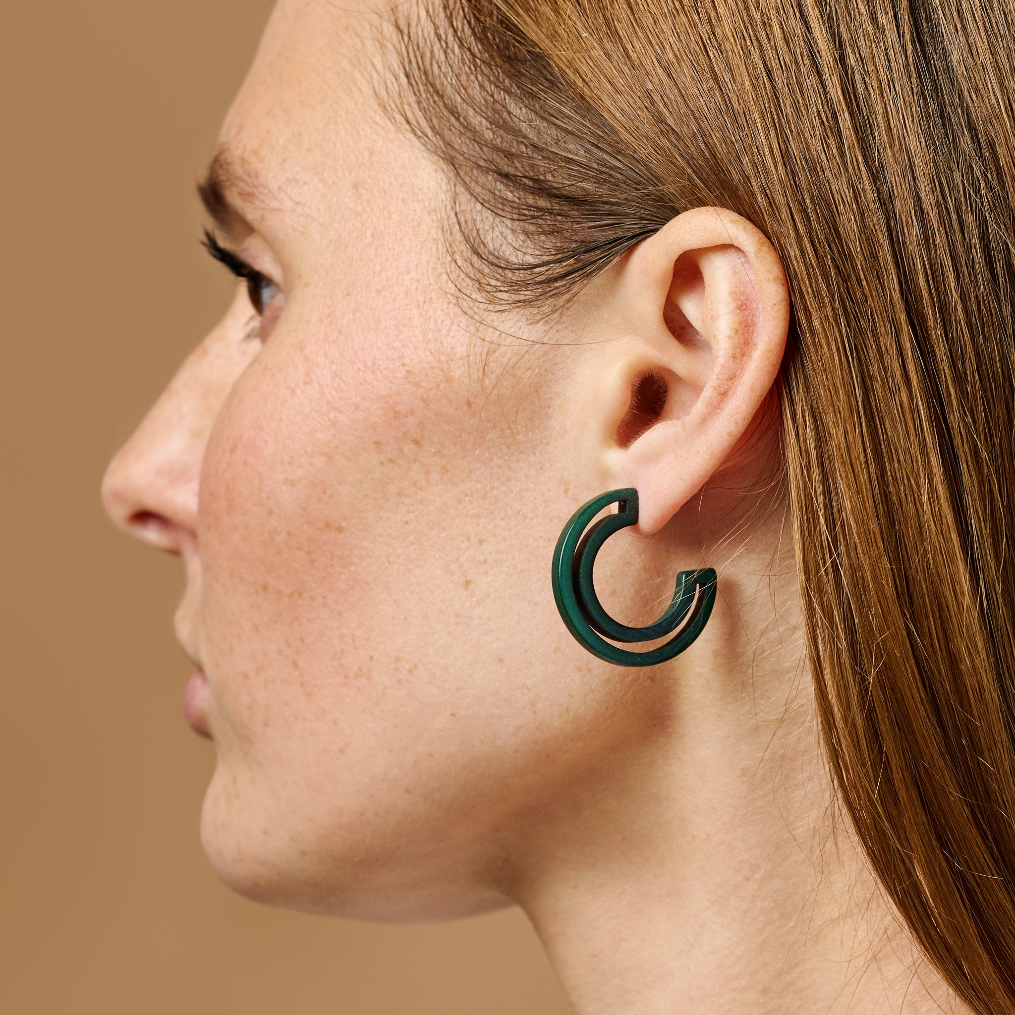 Close-up view of eco-friendly hoop earrings showcasing intricate craftsmanship and minimalist design.