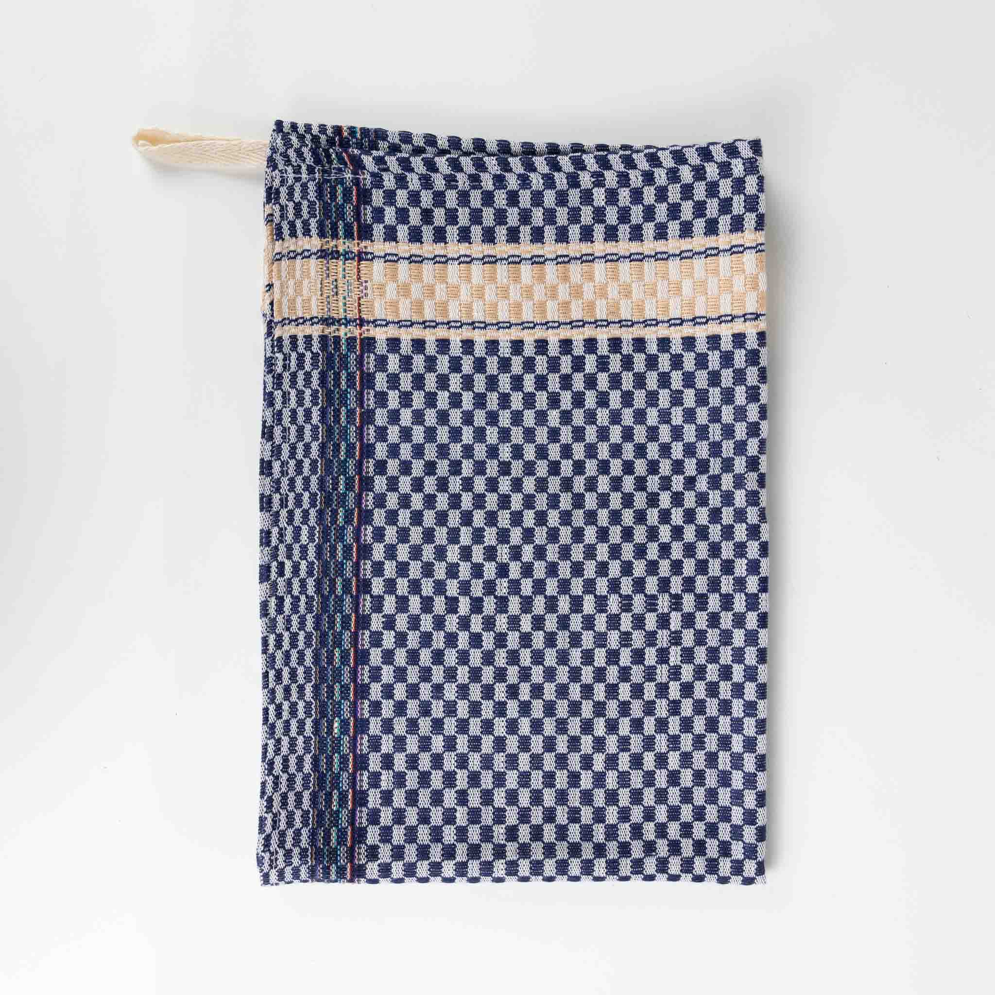 Artisan Blue Nile handwoven kitchen towel displayed on a kitchen counter, showcasing its absorbent texture.