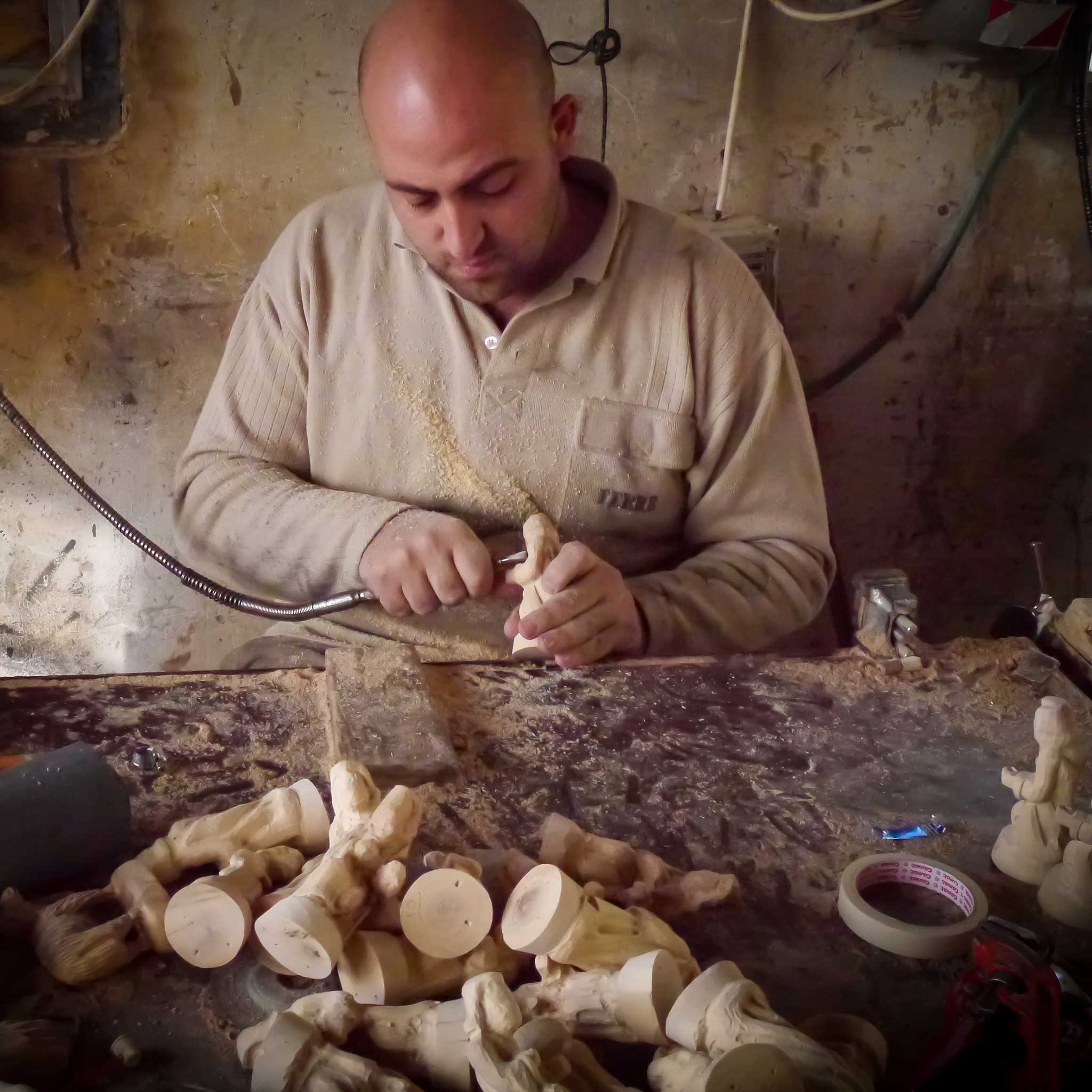Close-up of intricately carved olive wood nativity figurines