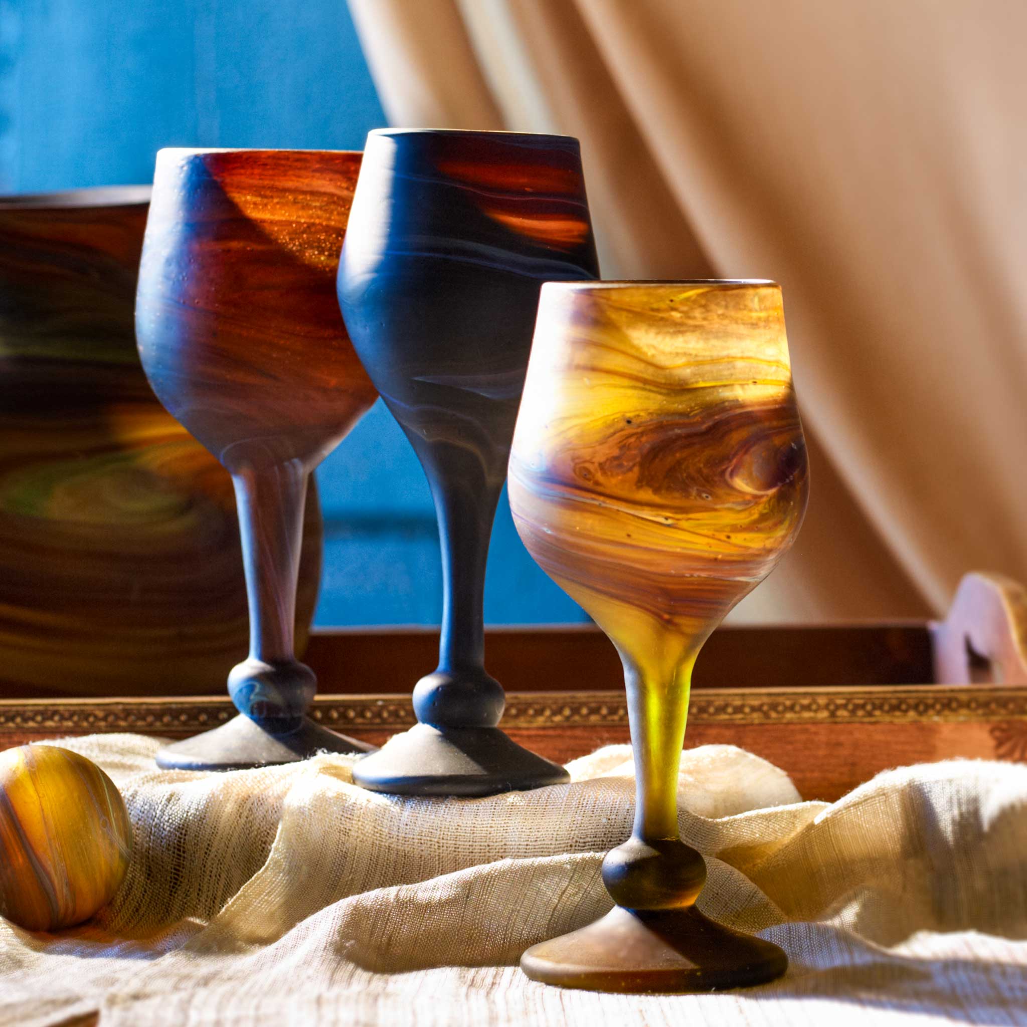 Close-up of a handblown Phoenician glass goblet with swirling colors