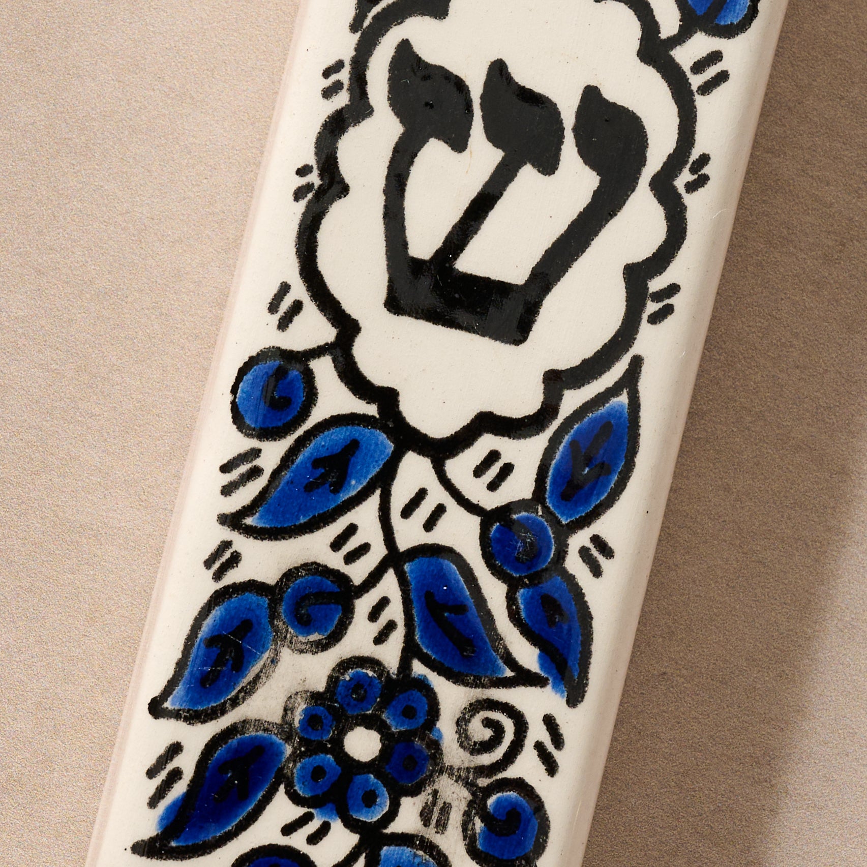 Jewish home decor featuring a vibrant Hebron Glass mezuzah