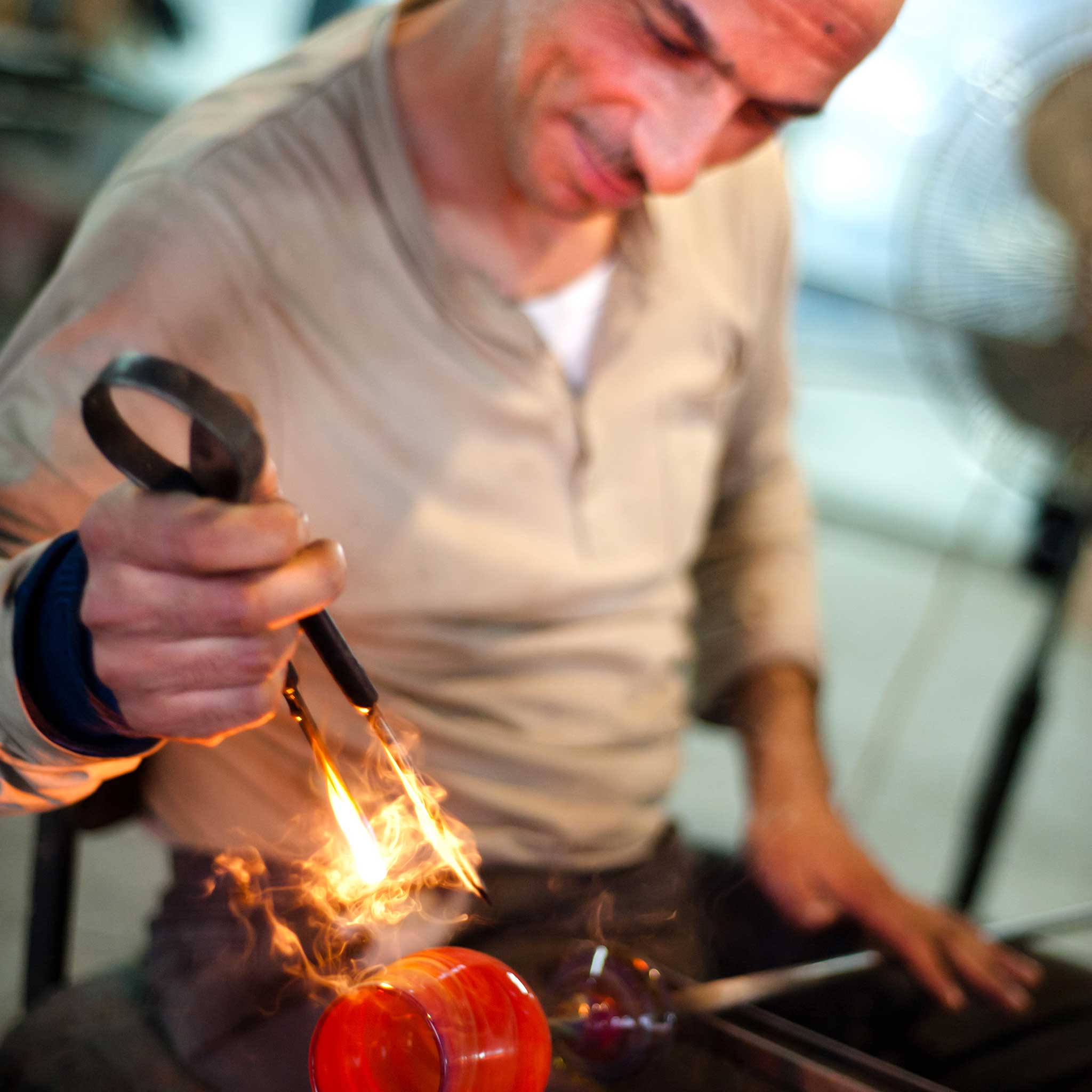 Natsheh handblown glass bulb ornament showcasing its unique swirl design in holiday setting