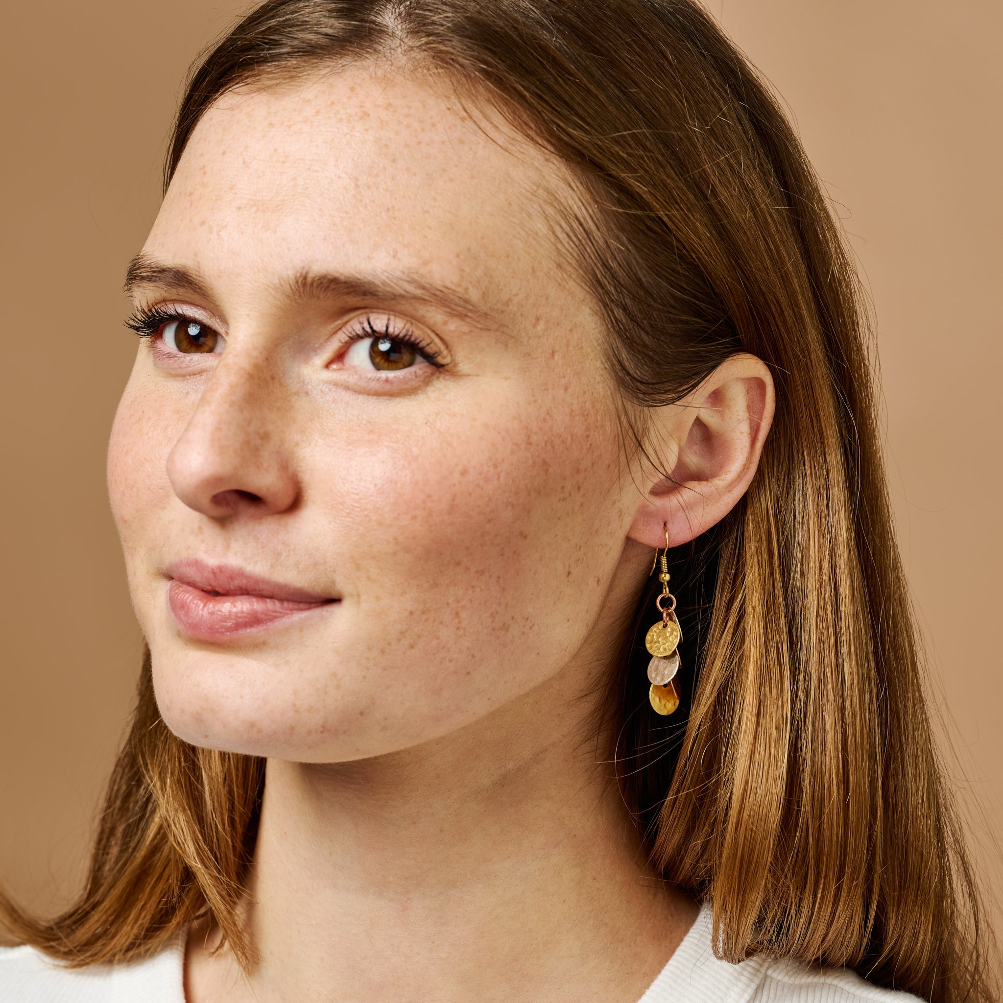 Close-up of mixed metal cluster earrings showing detailed craftsmanship