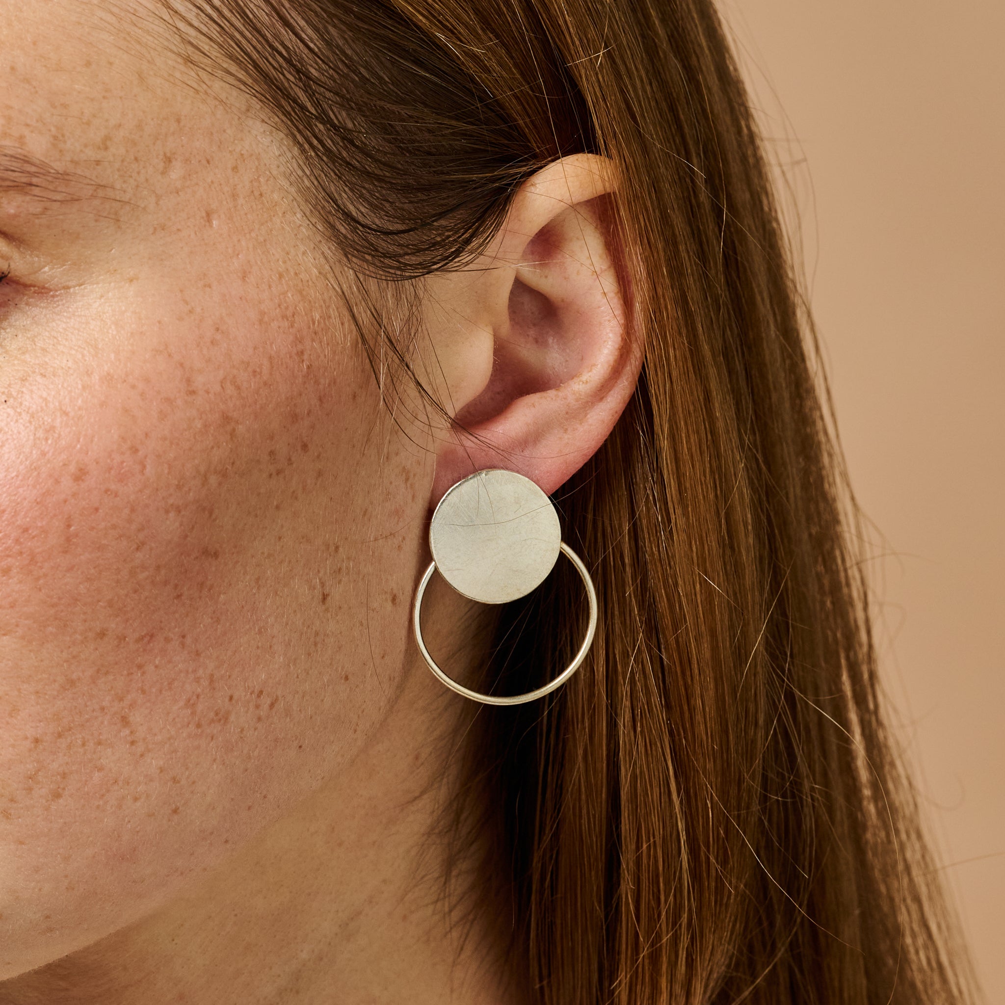 Close-up of Artisan Silver Hoop Earrings highlighting their unique handcrafted details.