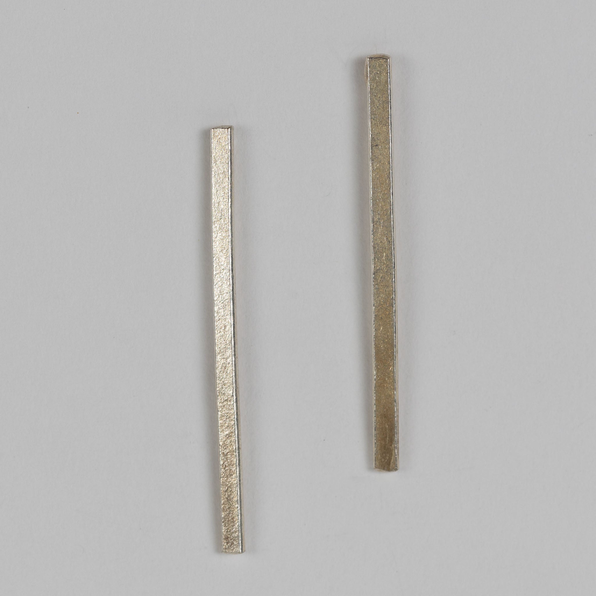Side view of the convertible silver brass bar drop earrings highlighting the craftsmanship.