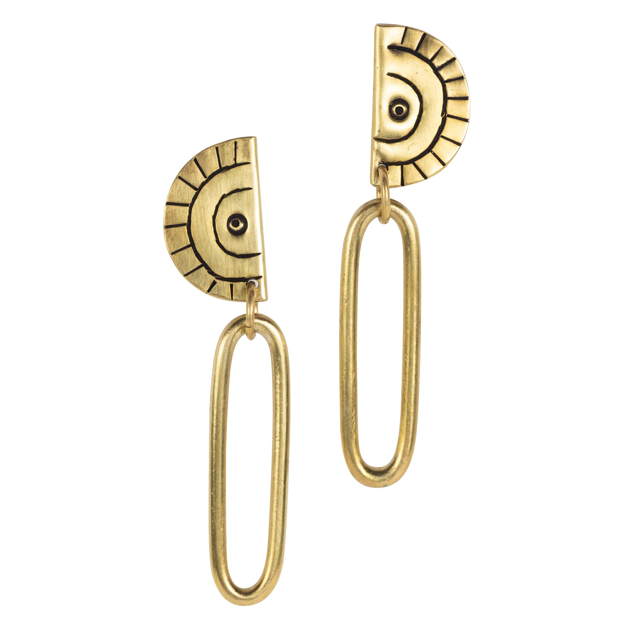 Model wearing brass drop earrings styled with casual outfit, highlighting their bold presence.