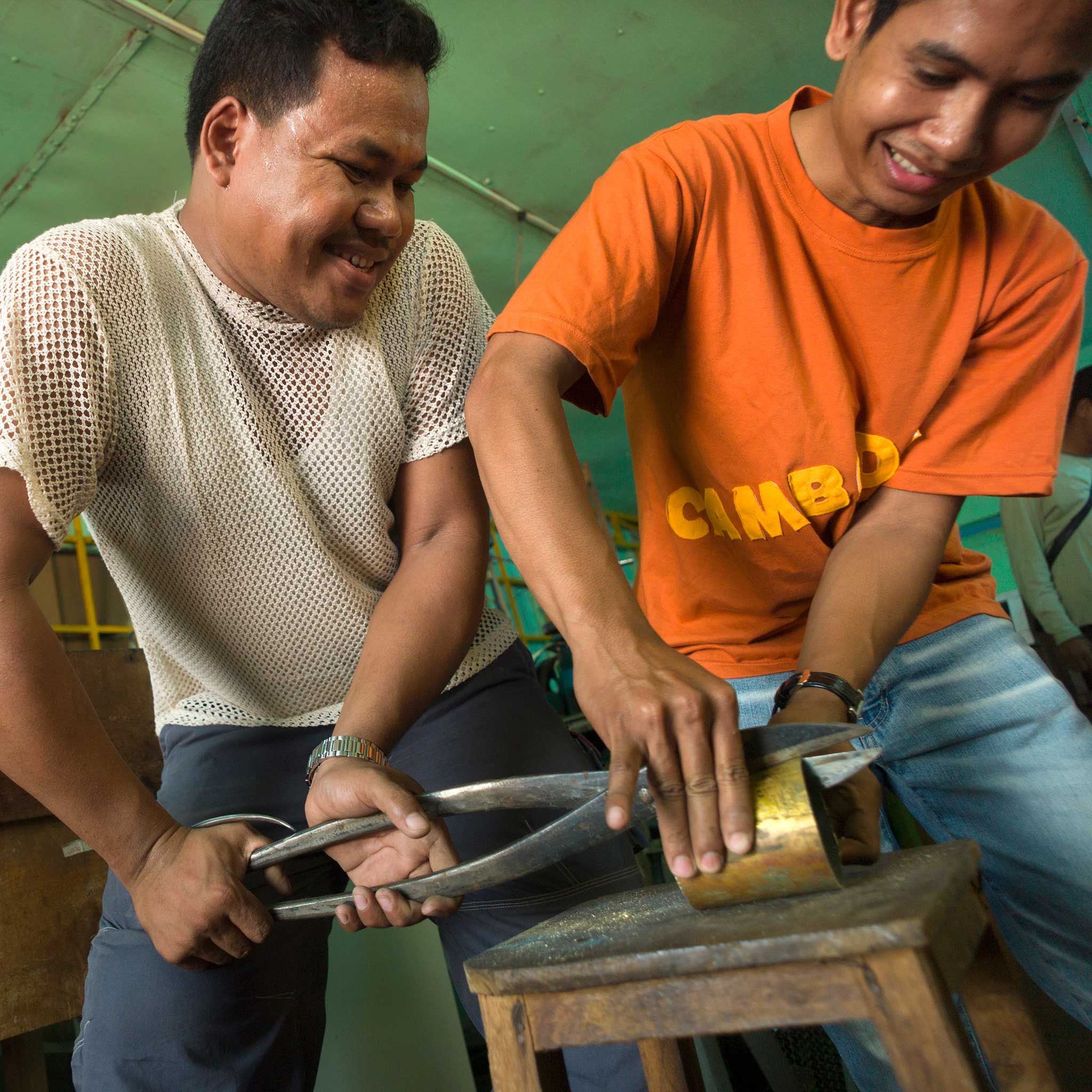 Artisan crafting the peace necklace from recycled brass, highlighting fair trade practices.