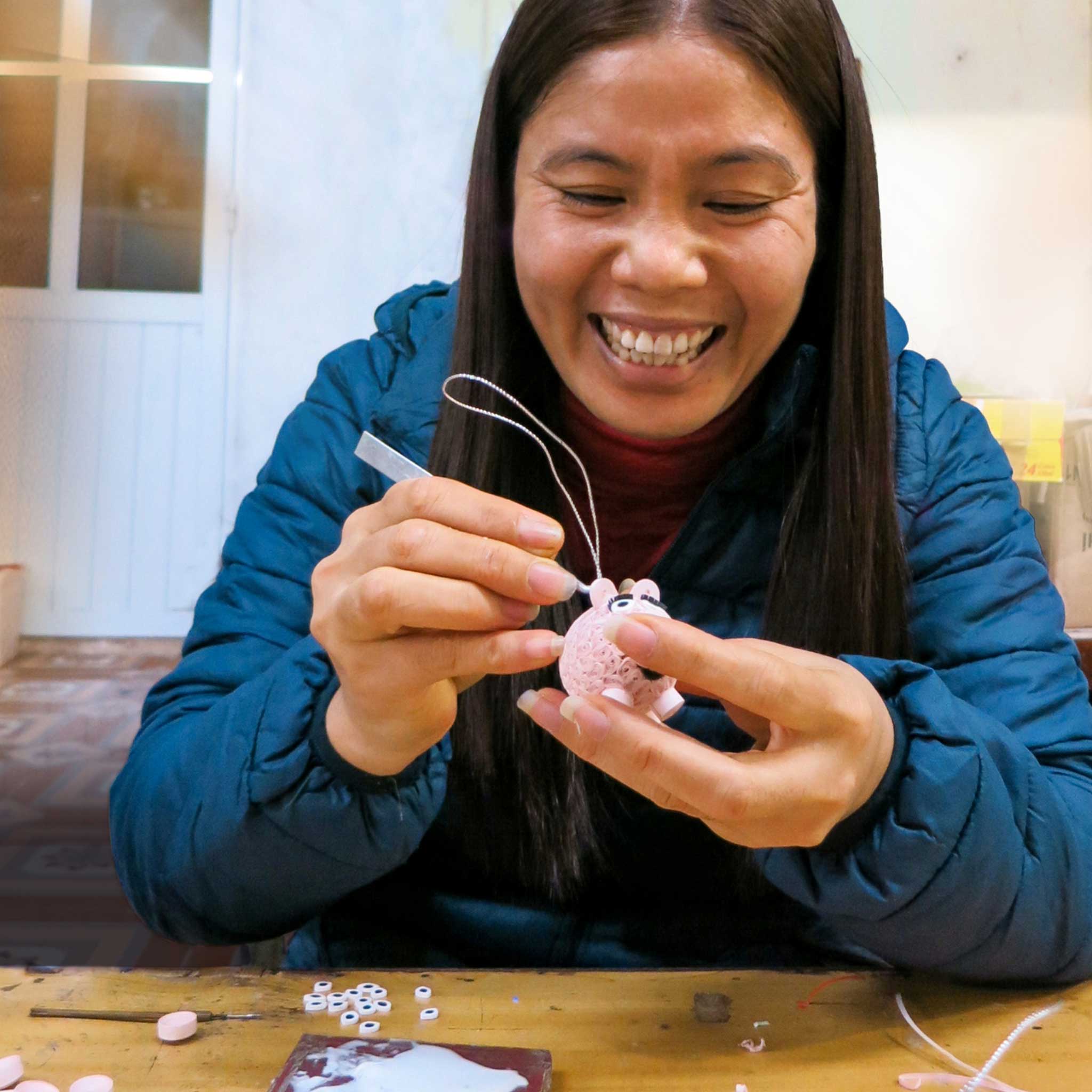 Recycled newspaper tree ornament shown in gift-ready packaging for holiday giving