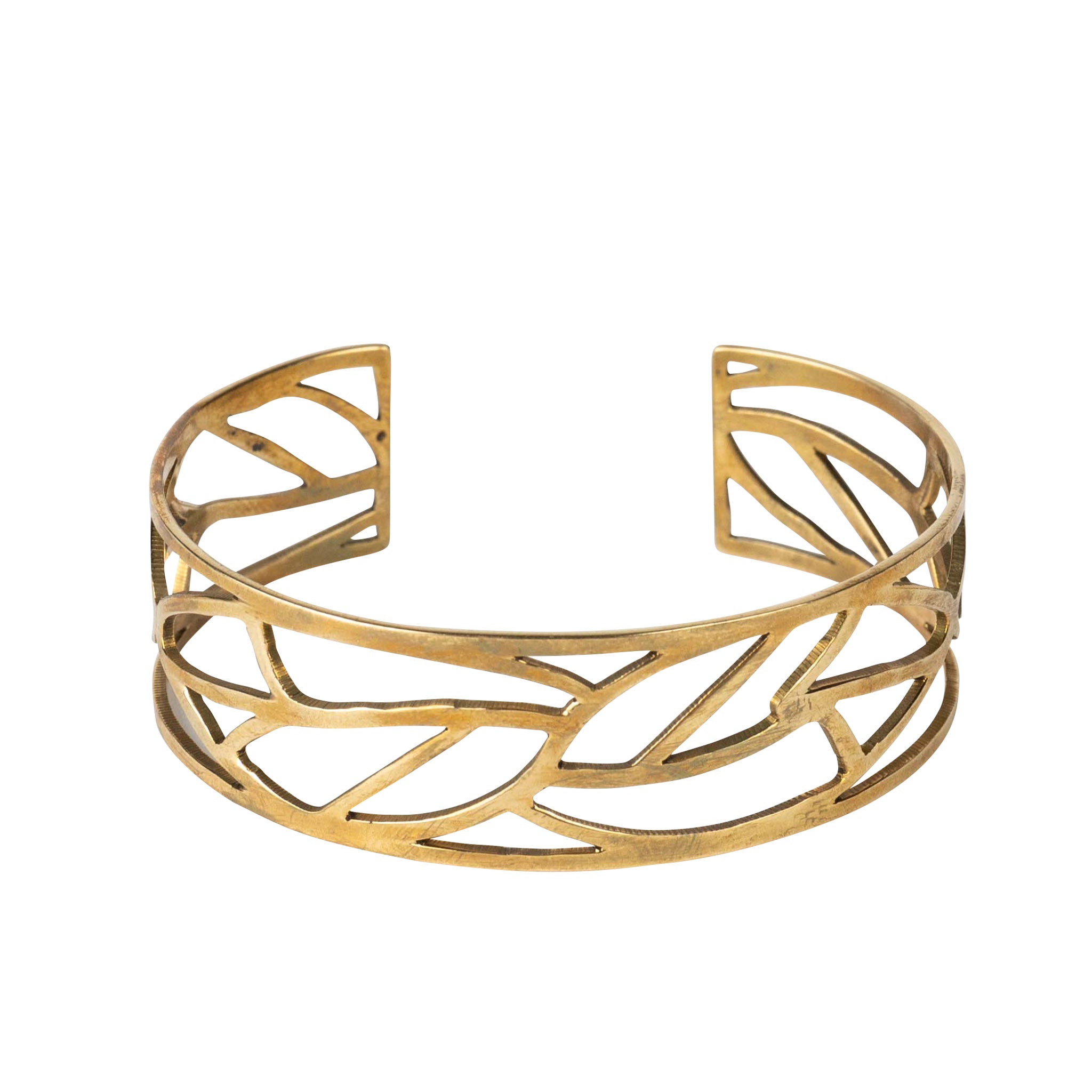 Model wearing brass bangle with a flowing dress, highlighting its bohemian charm.