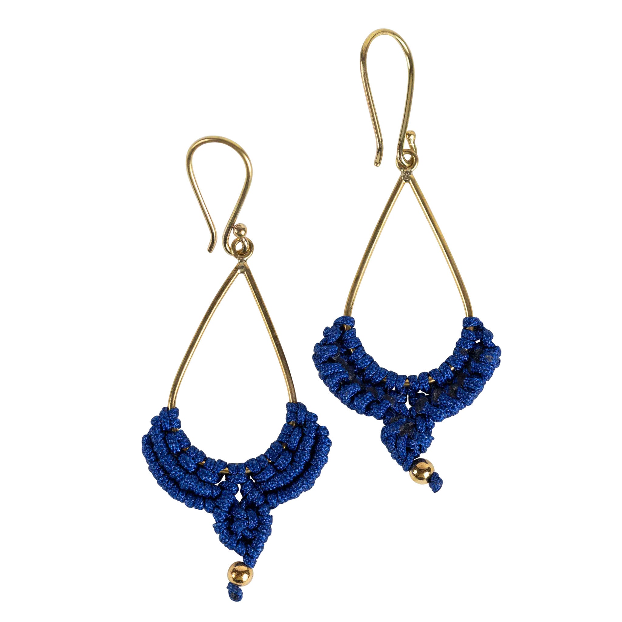 Close-up of handmade macrame rain drop earrings with navy cording on brass hoops