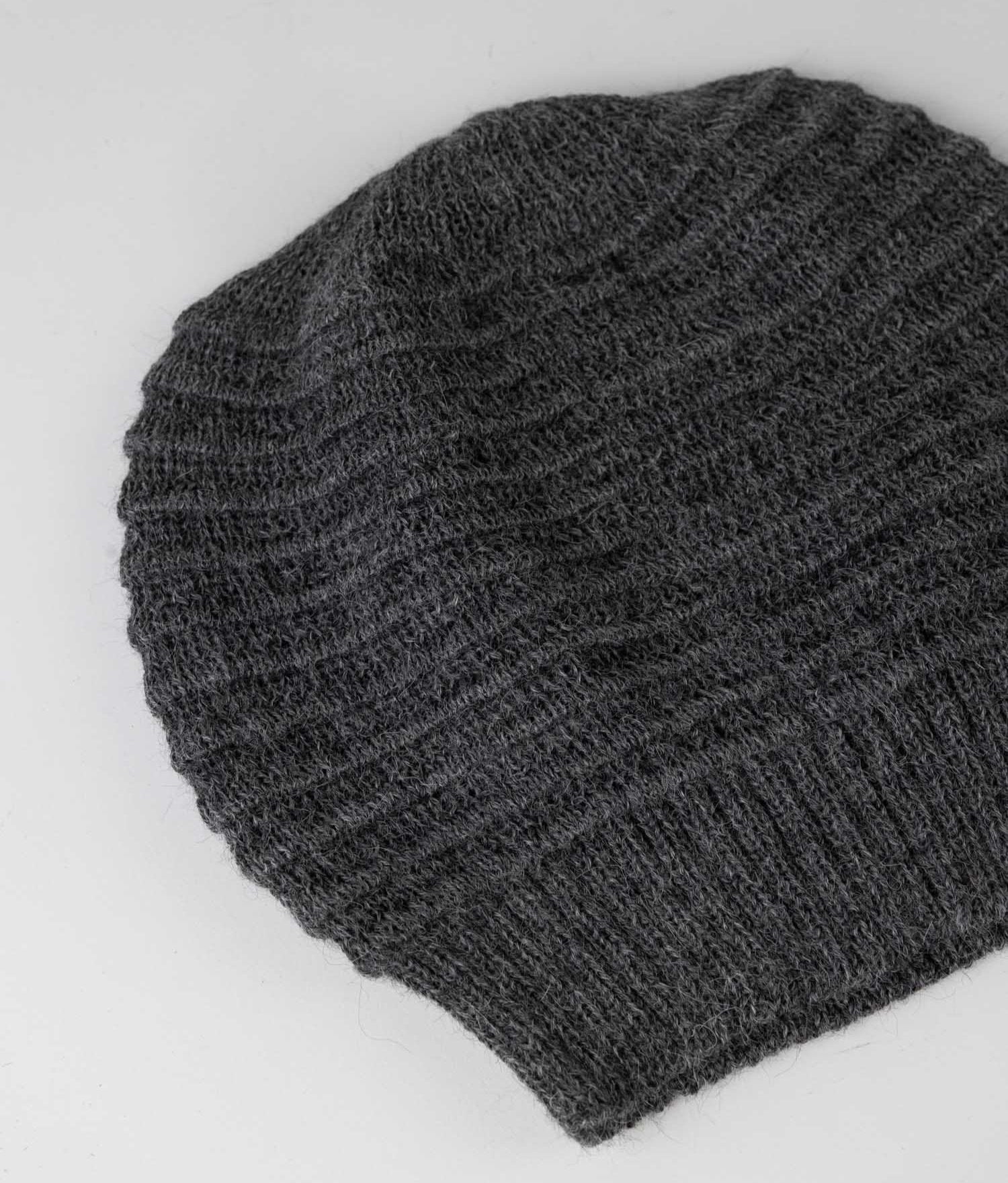 Artisan crafting the alpaca hat, highlighting the handmade quality.