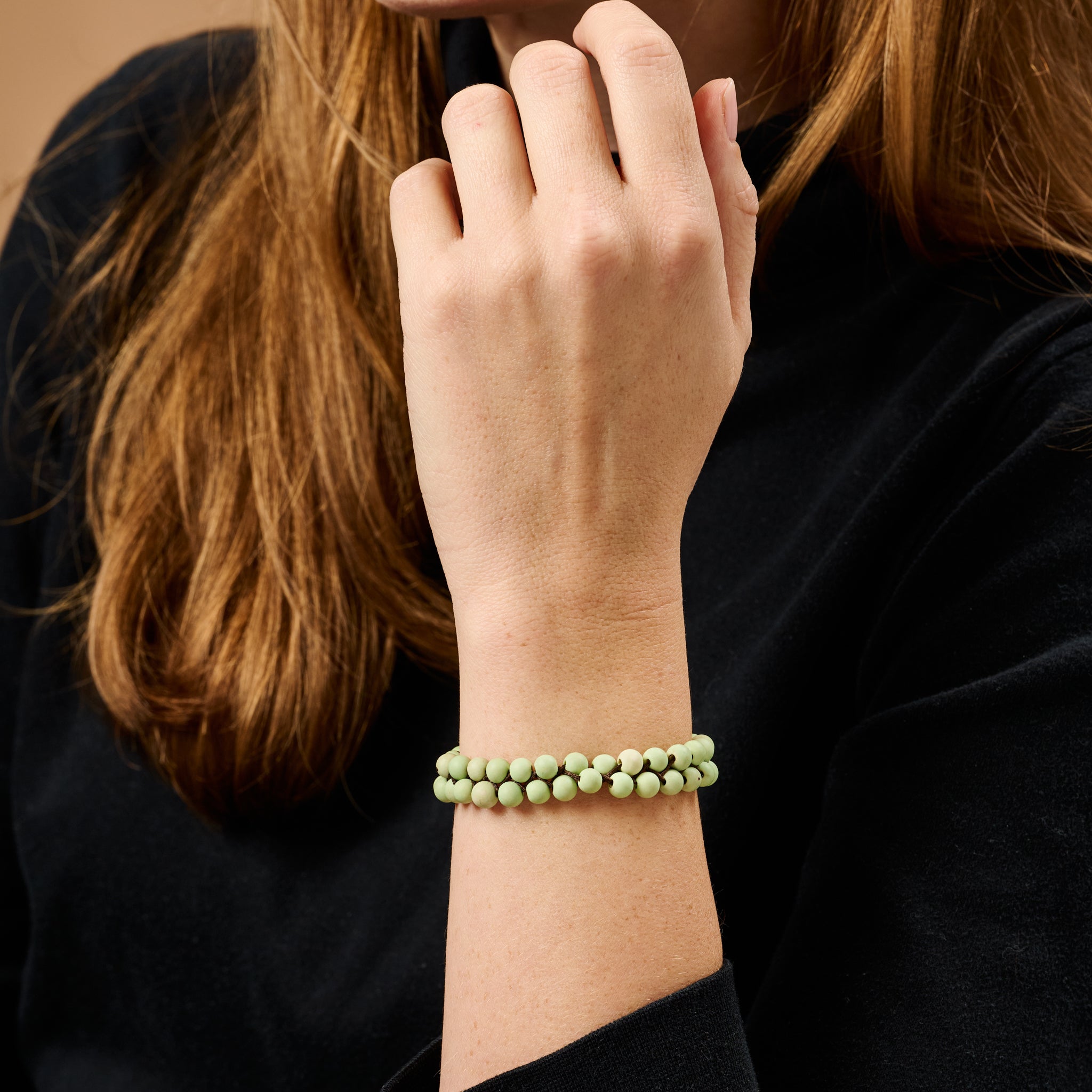 Earthy Elegance Chirilla Seed Bracelet on a wooden background, highlighting its natural beauty.