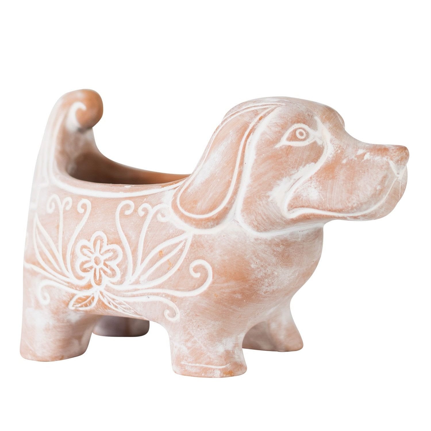 Front view of handcrafted terracotta dog planter with greenery