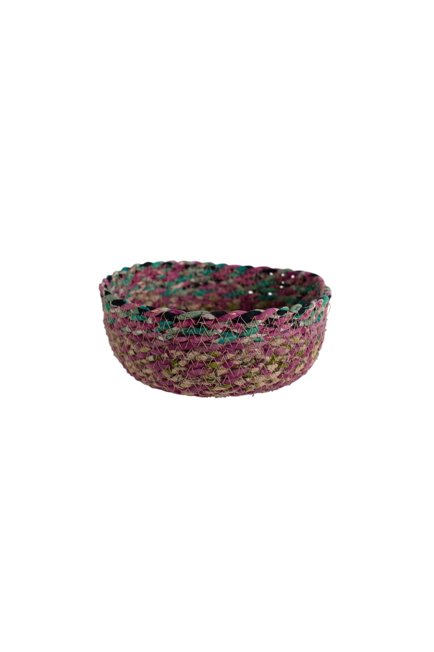Recycled fabric artisan woven basket displayed in a modern living room setting.