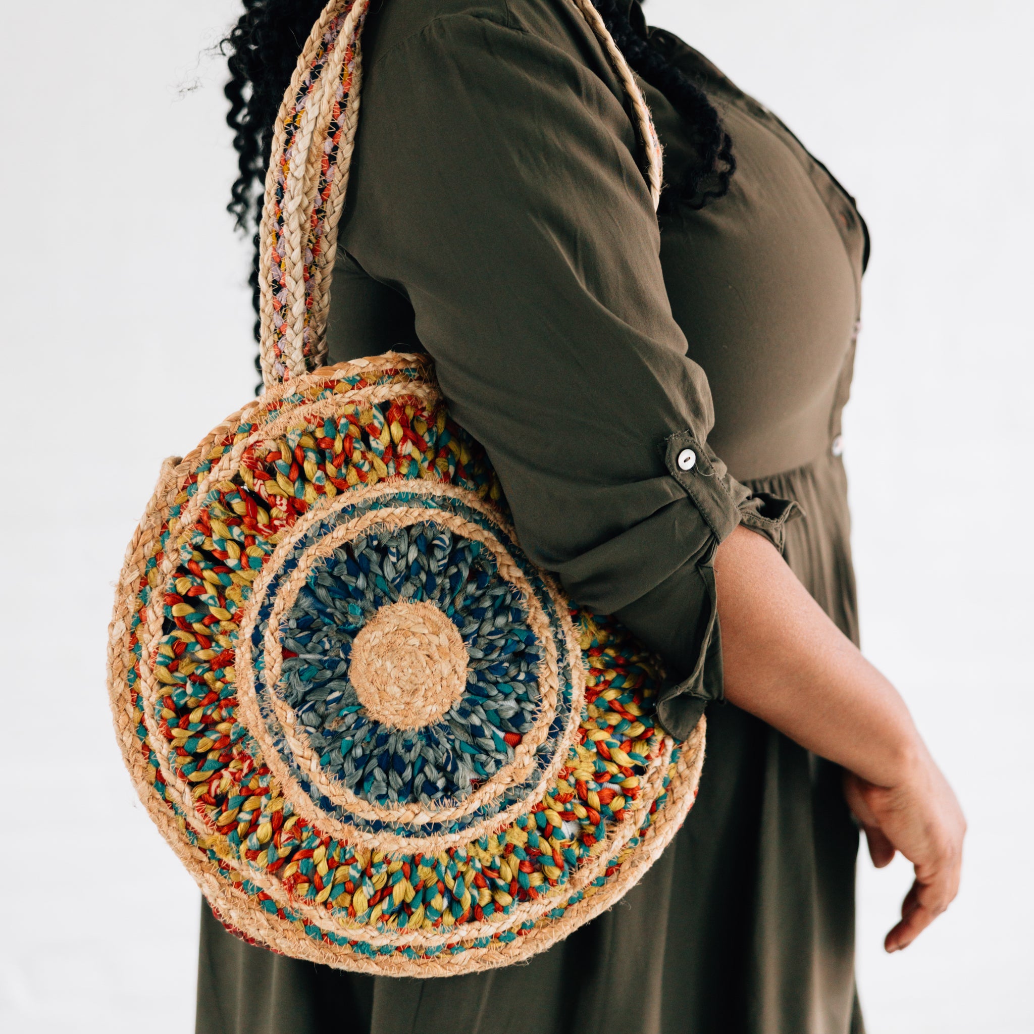Eco-Friendly Round Sari Jute Shoulder Bag displayed on a table, showcasing its intricate design.