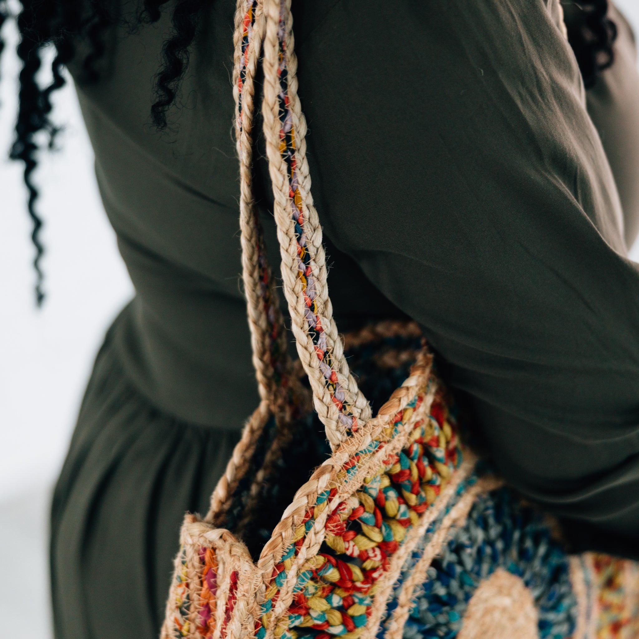 A woman carrying the Eco-Friendly Round Sari Jute Shoulder Bag while running errands, highlighting its practicality.