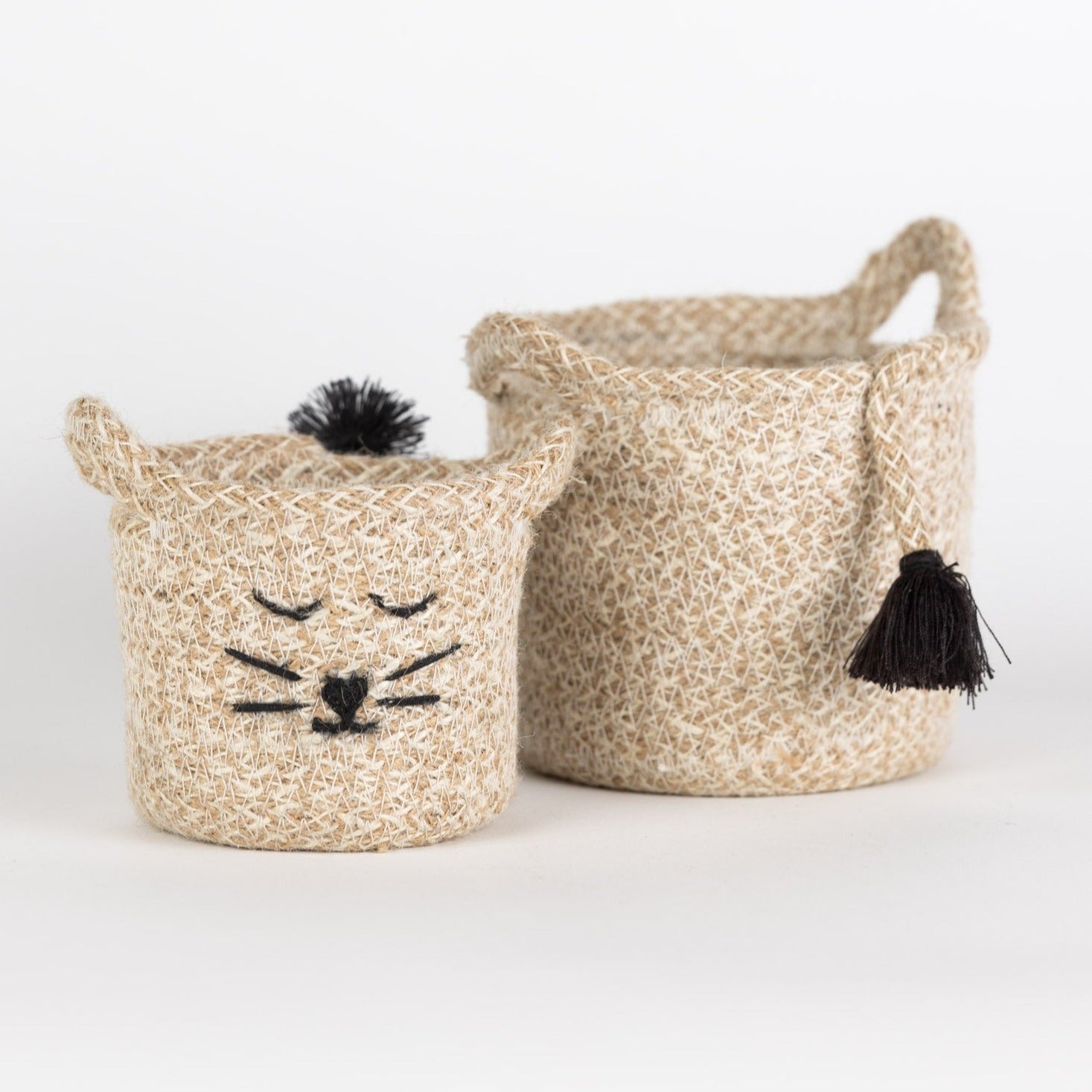 Close-up of a handcrafted eco-friendly jute basket with a cat face decoration, ideal for home decor.