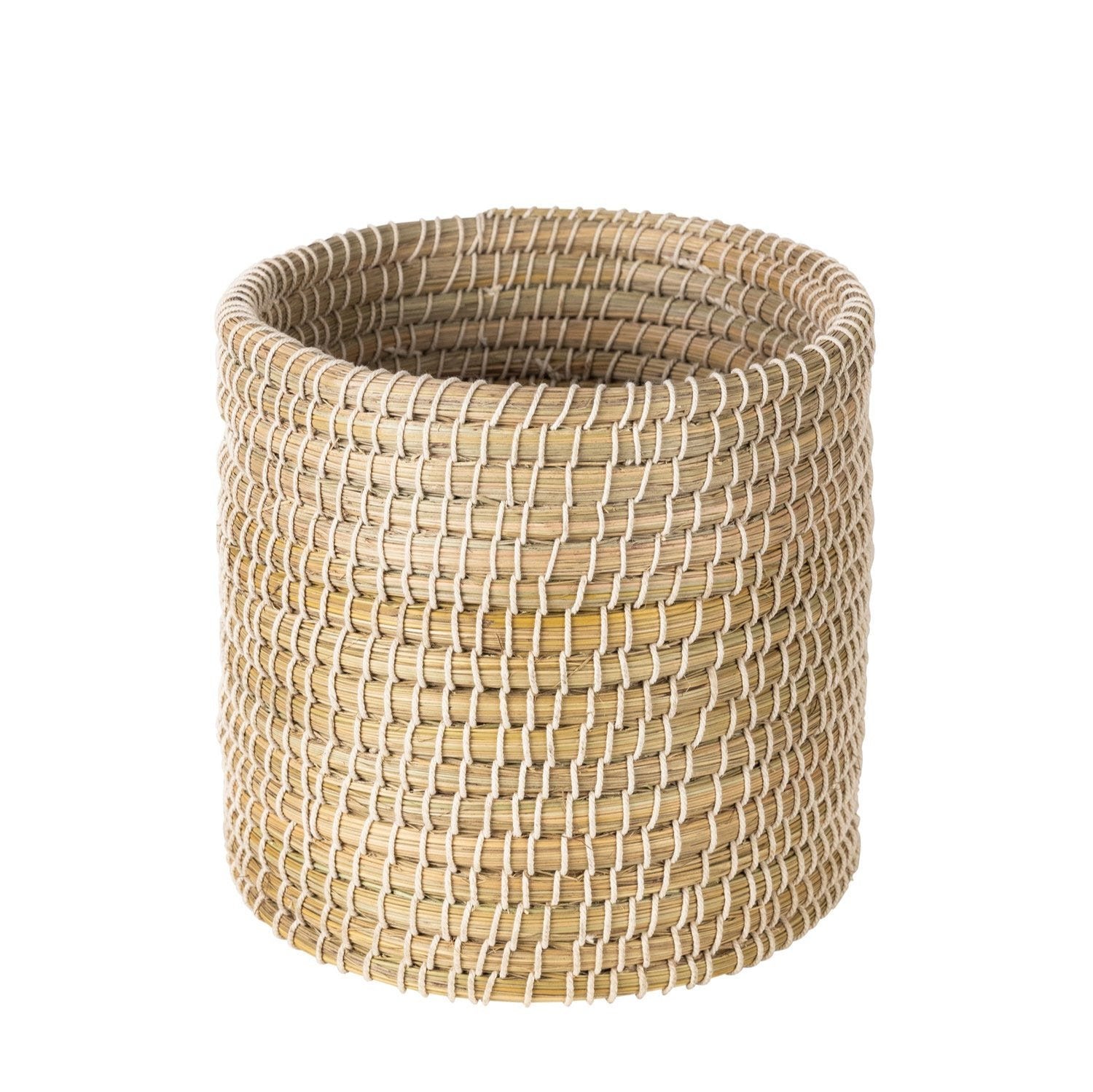 Side angle of the basket placed in a living room corner as a stylish clutter solution