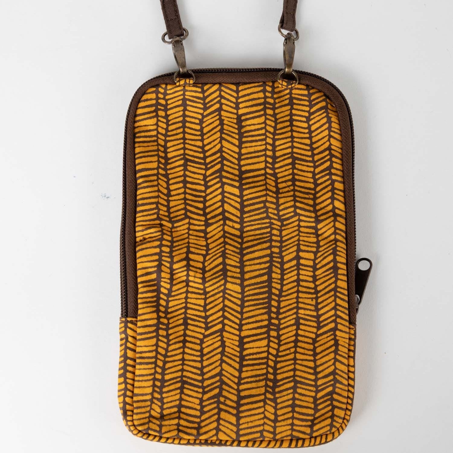 Artisan sewing recycled sari fabric into a stylish festival bag