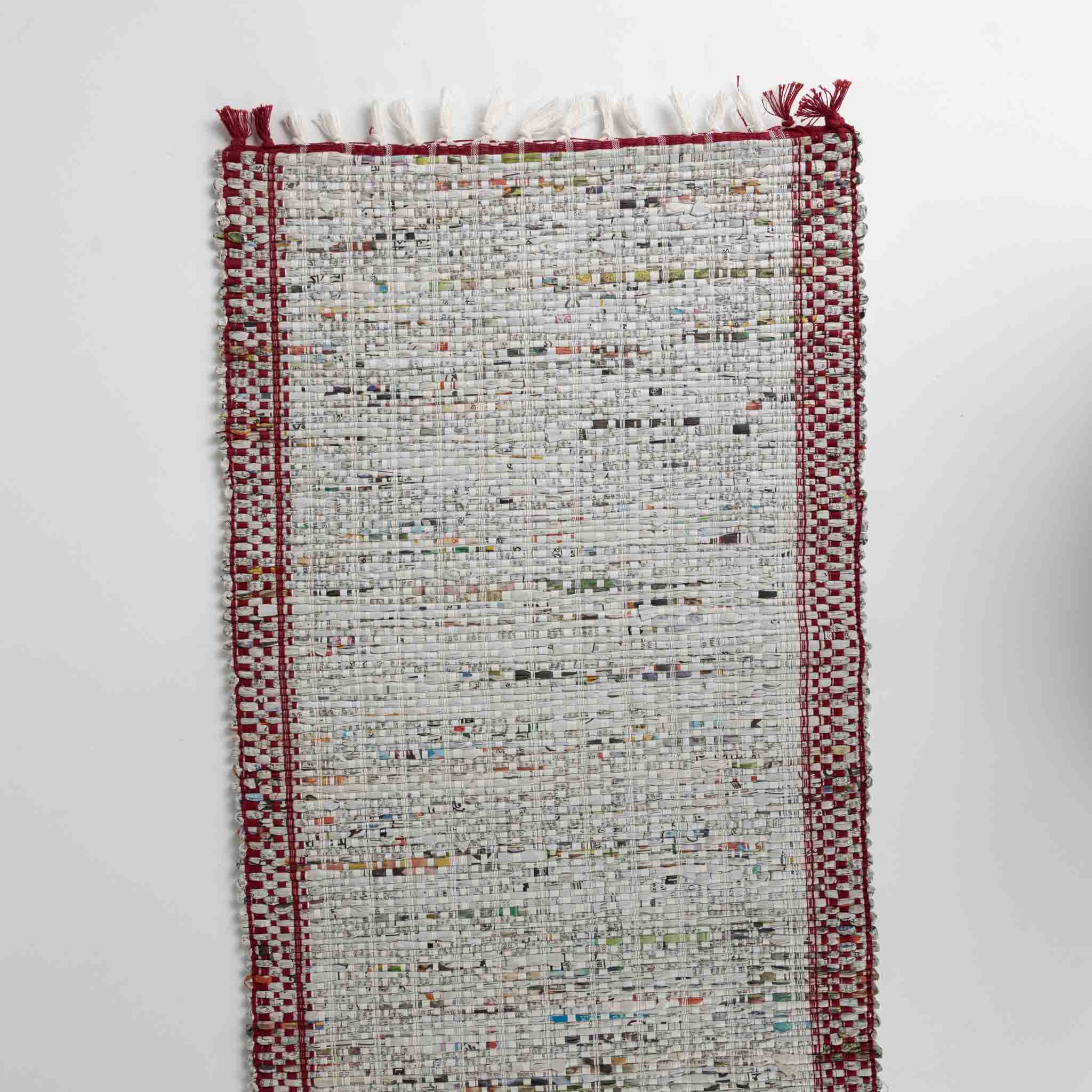 Close-up of the recycled newspaper table runner, highlighting the craftsmanship and eco-friendly materials.