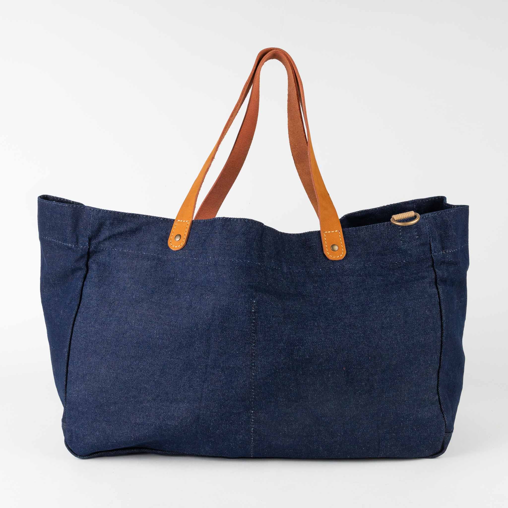 Side view of upcycled denim weekender bag with drawstring closure