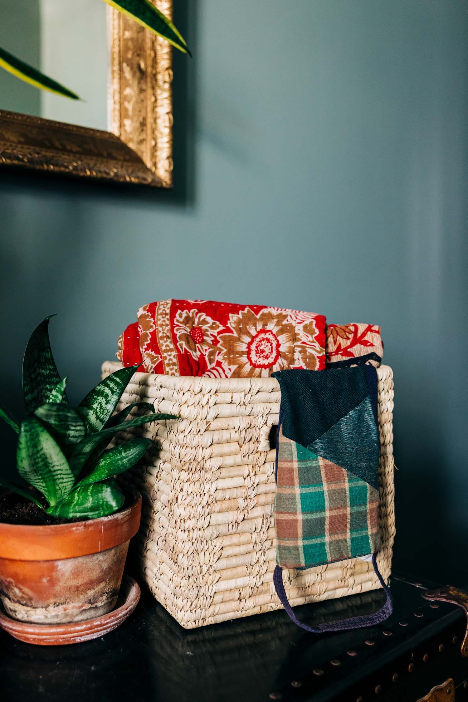 Woven basket used for organizing toys and linens in a modern home