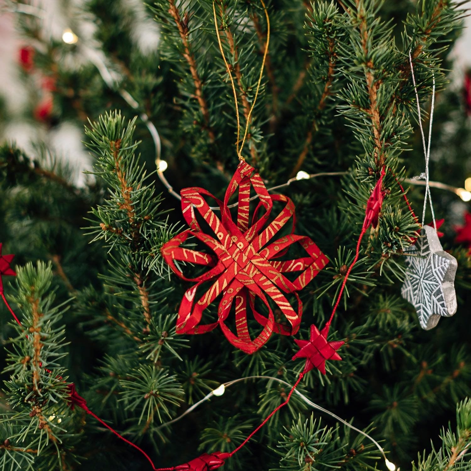 Close-up view of the intricate design of the gold ornament, highlighting its fine details.