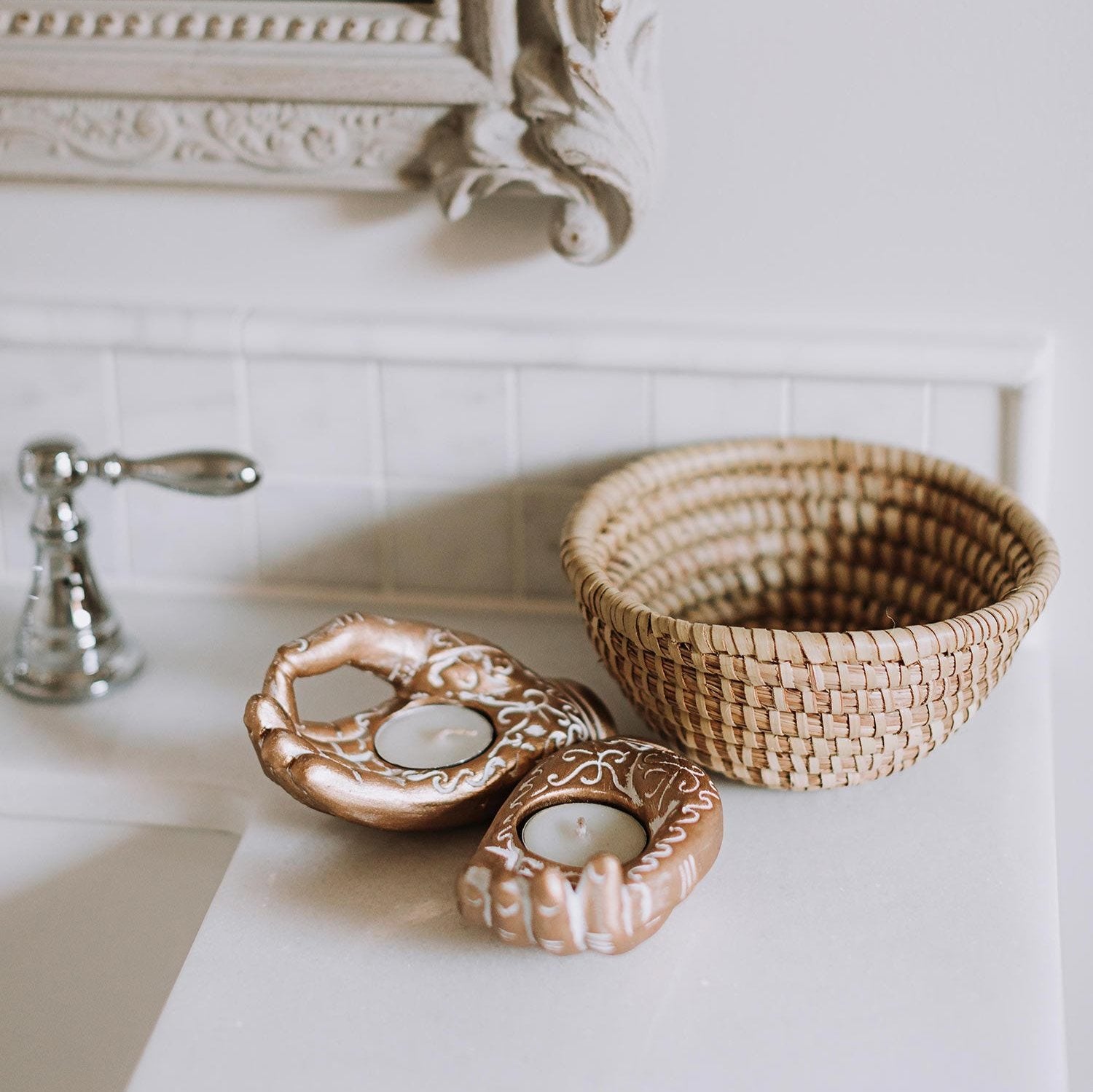 Top-down view of the handmade kaisa grass basket bowl on an entryway table with keys and coins inside
