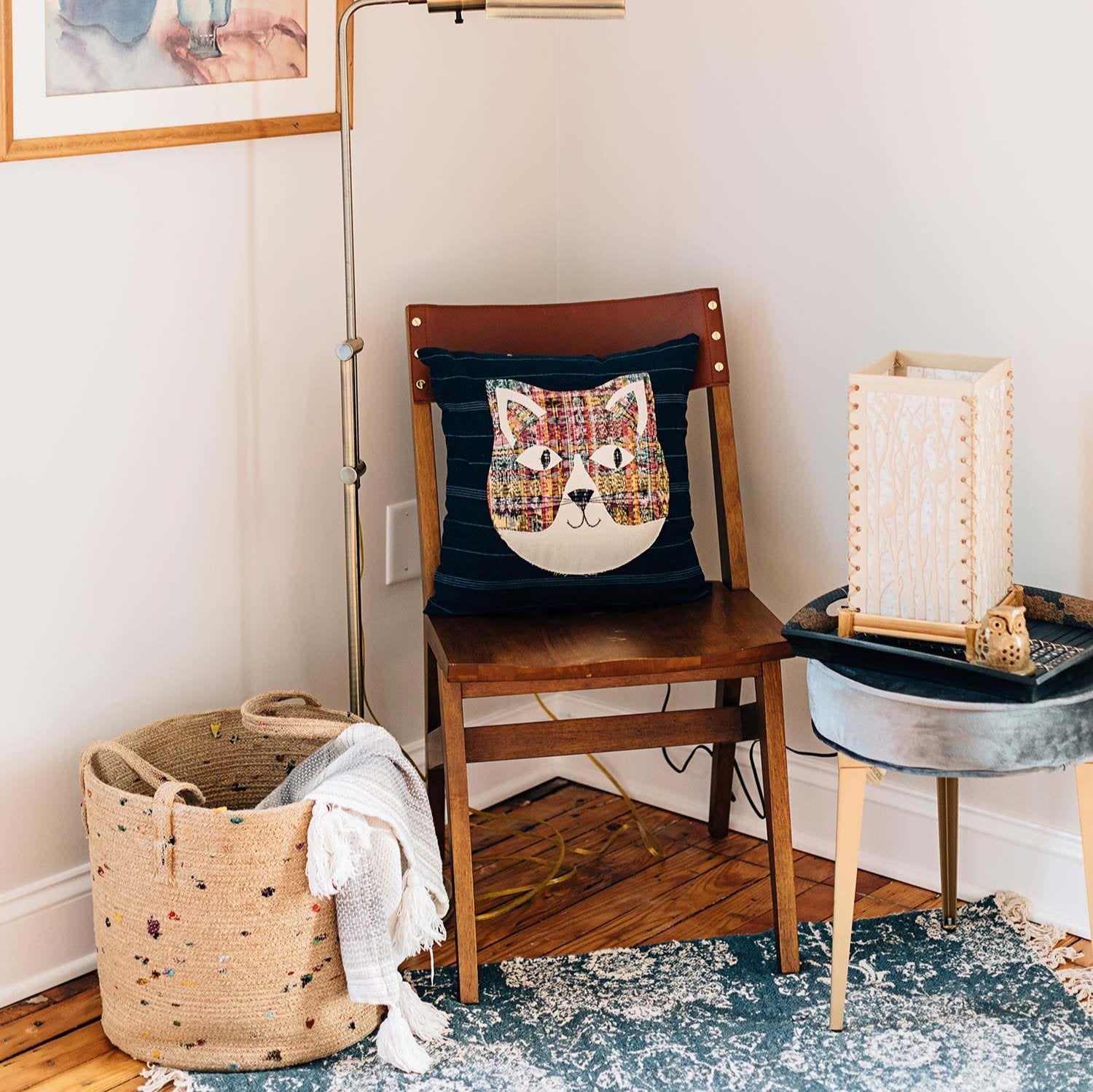 Vibrant jute basket in a cozy entryway, showcasing colorful sari fabric.