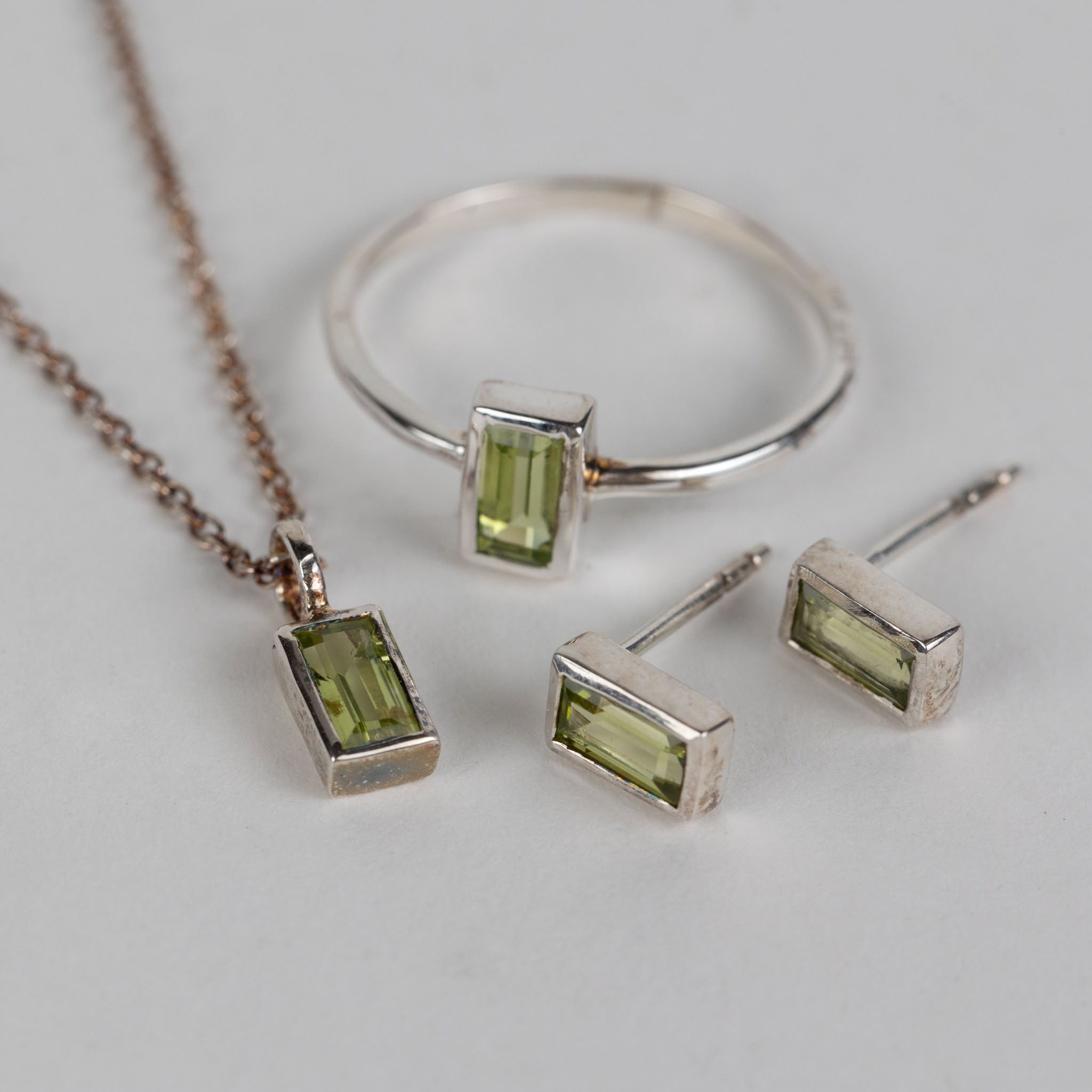 Detailed view of the peridot silver pendant necklace on a display, emphasizing craftsmanship.