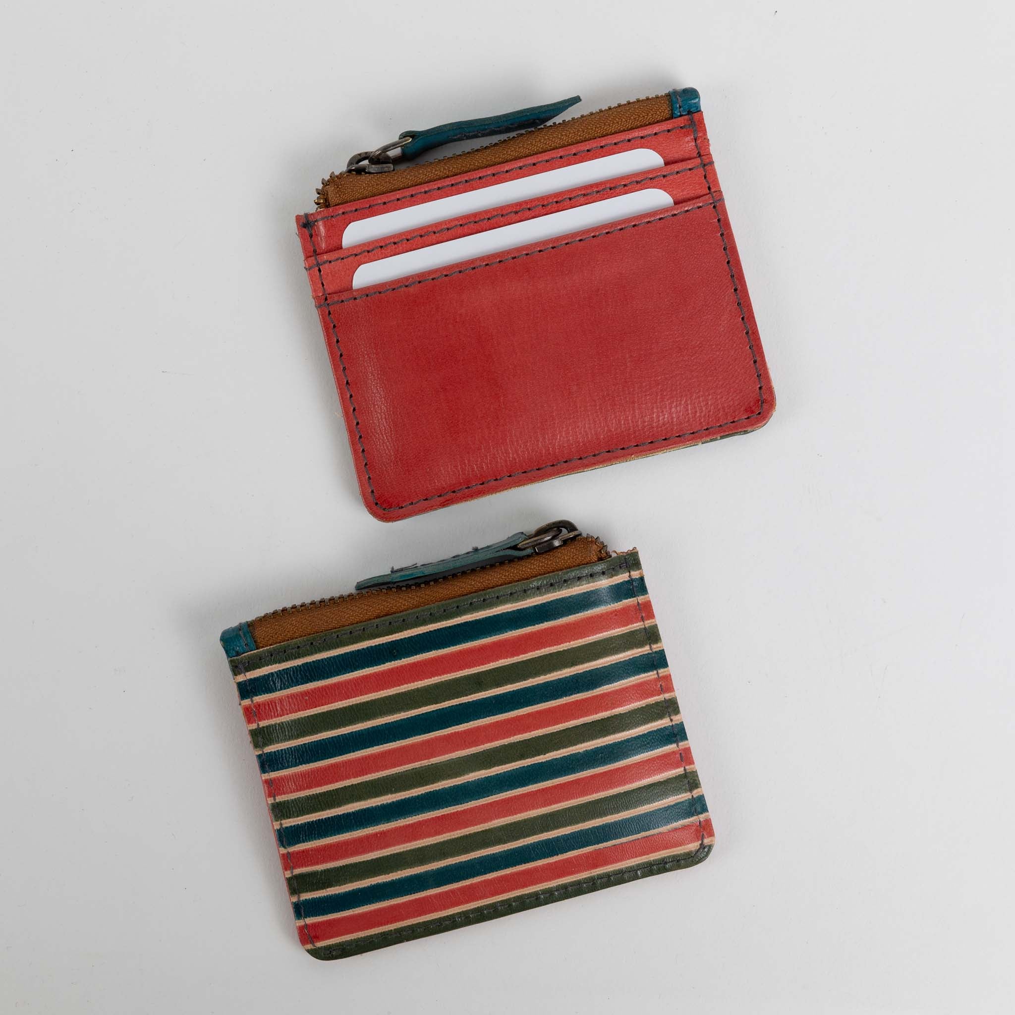 Open view of the compact leather card case, highlighting the card slots and zip pocket.