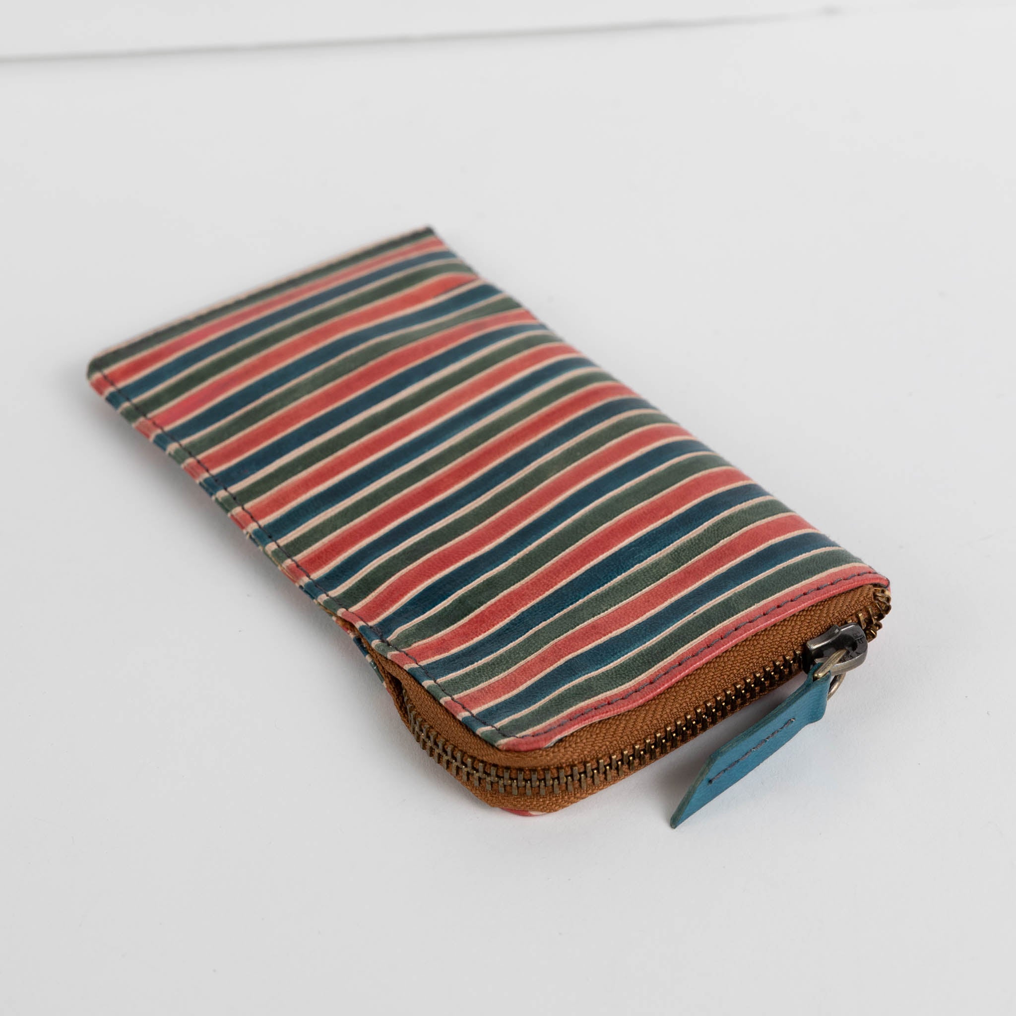 Artisan hands crafting the leather glasses case, highlighting the handmade quality.