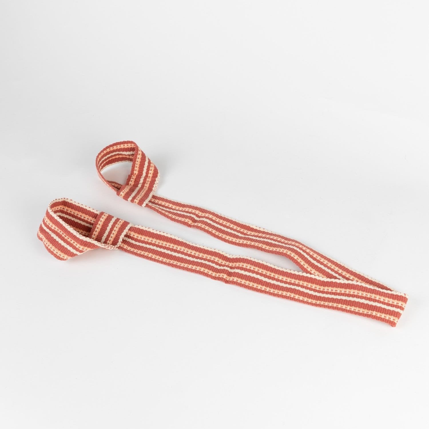 Yoga accessories including a stretching strap for enhanced flexibility in a yoga studio