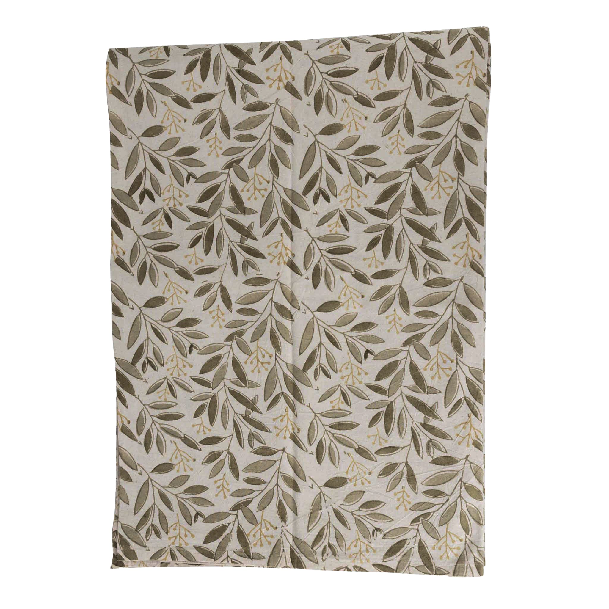 Artisan Green Bounty Tablecloth displayed on a rustic dining table, showcasing its vibrant block printed patterns.