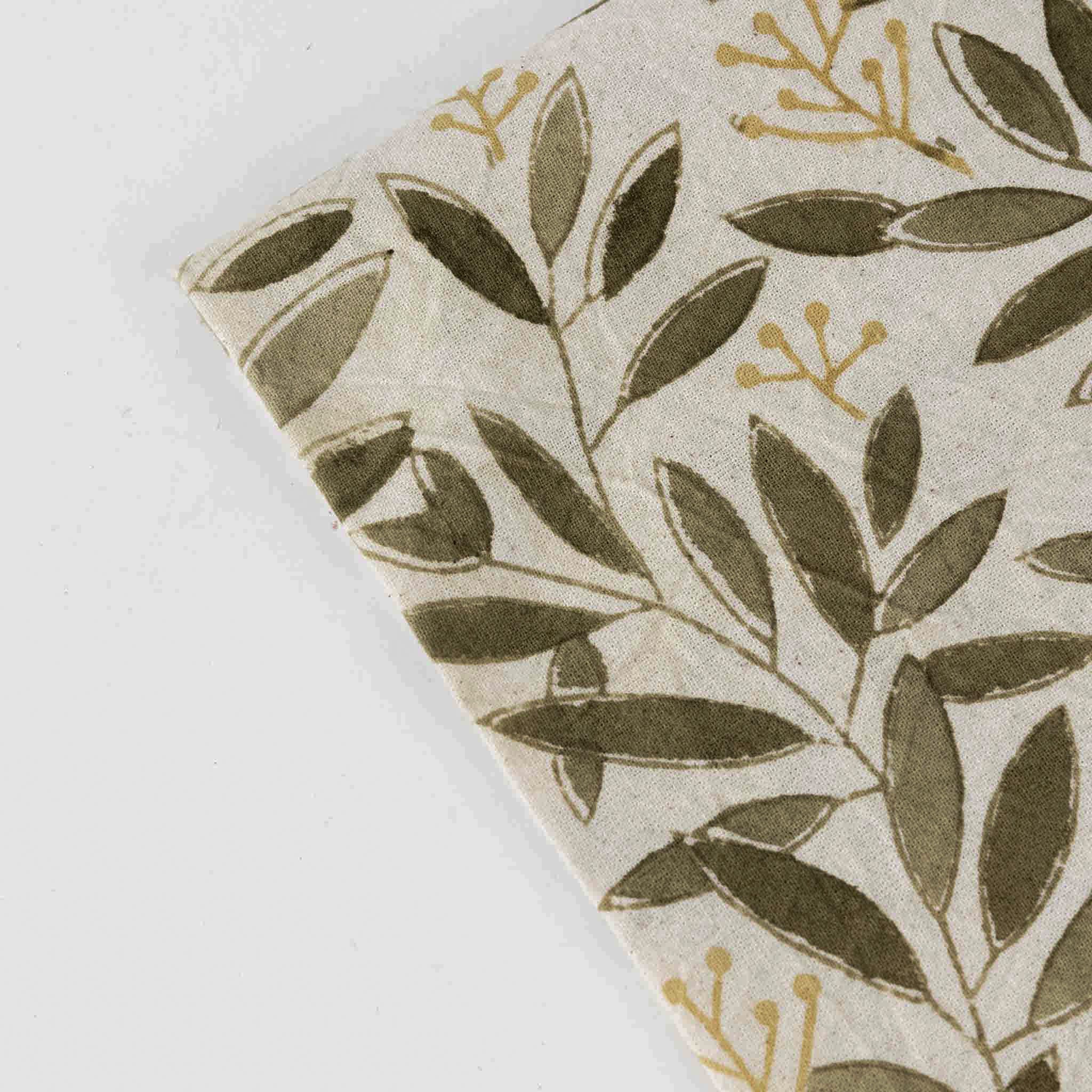 Close-up of the Artisan Green Bounty Tablecloth fabric, highlighting the intricate details of the hand-printed design.