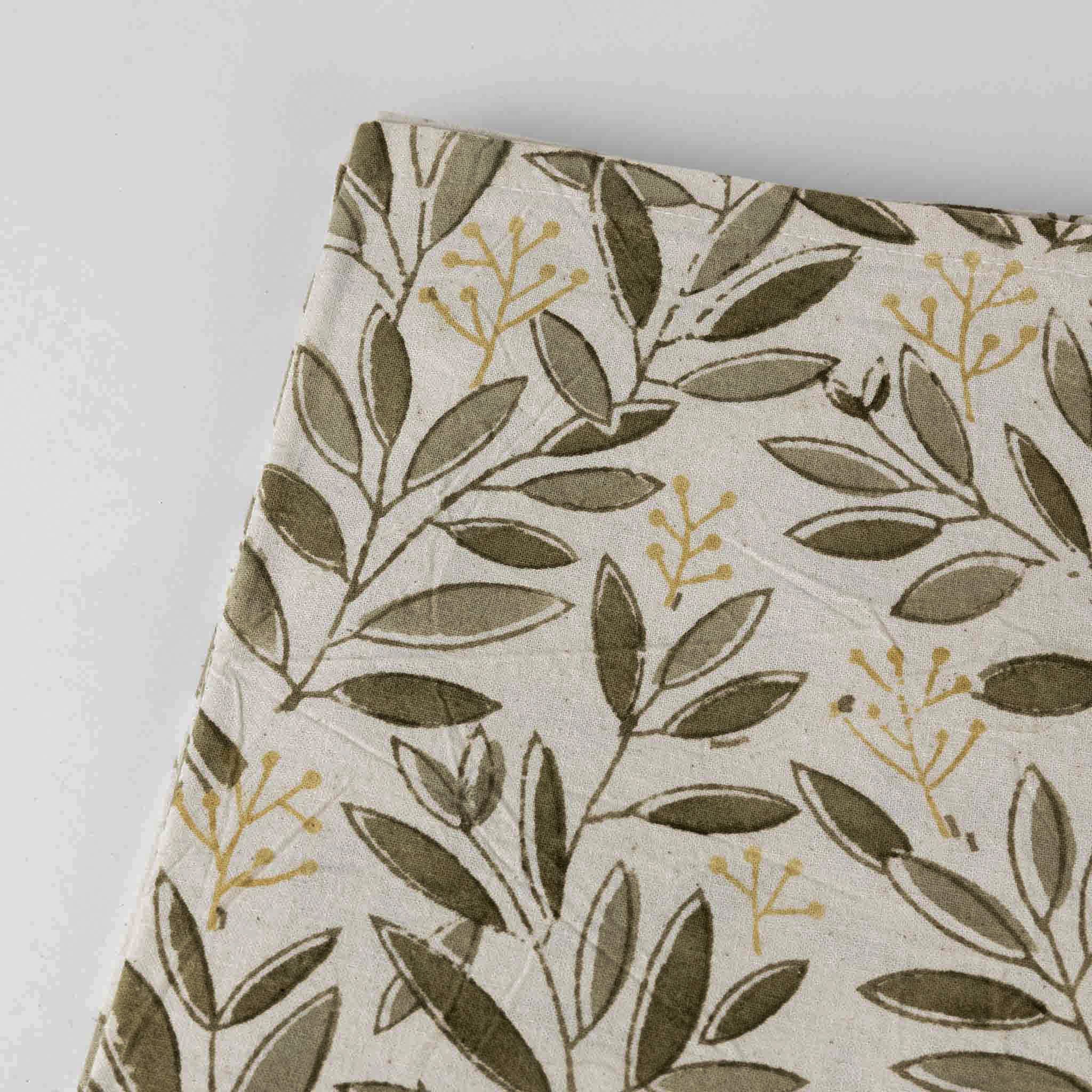 Artisan Green Bounty Tablecloth set for a festive dinner, featuring elegant tableware that complements the block printed fabric.