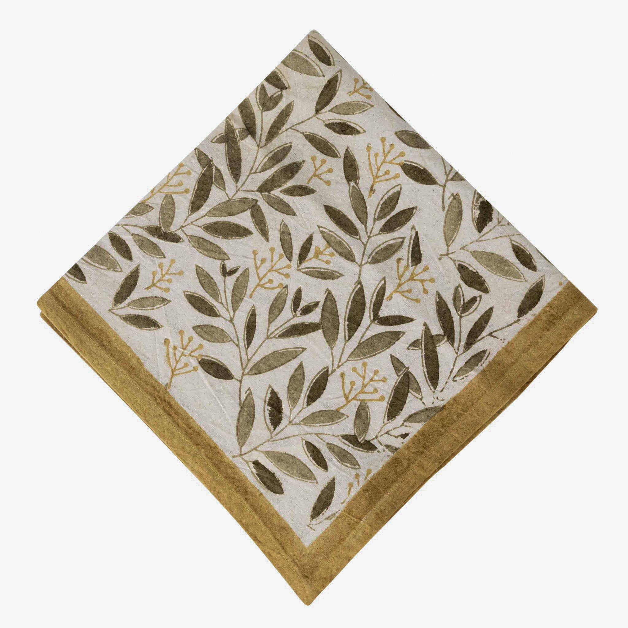 Artisan hand-placing natural dye on block printed cotton napkins