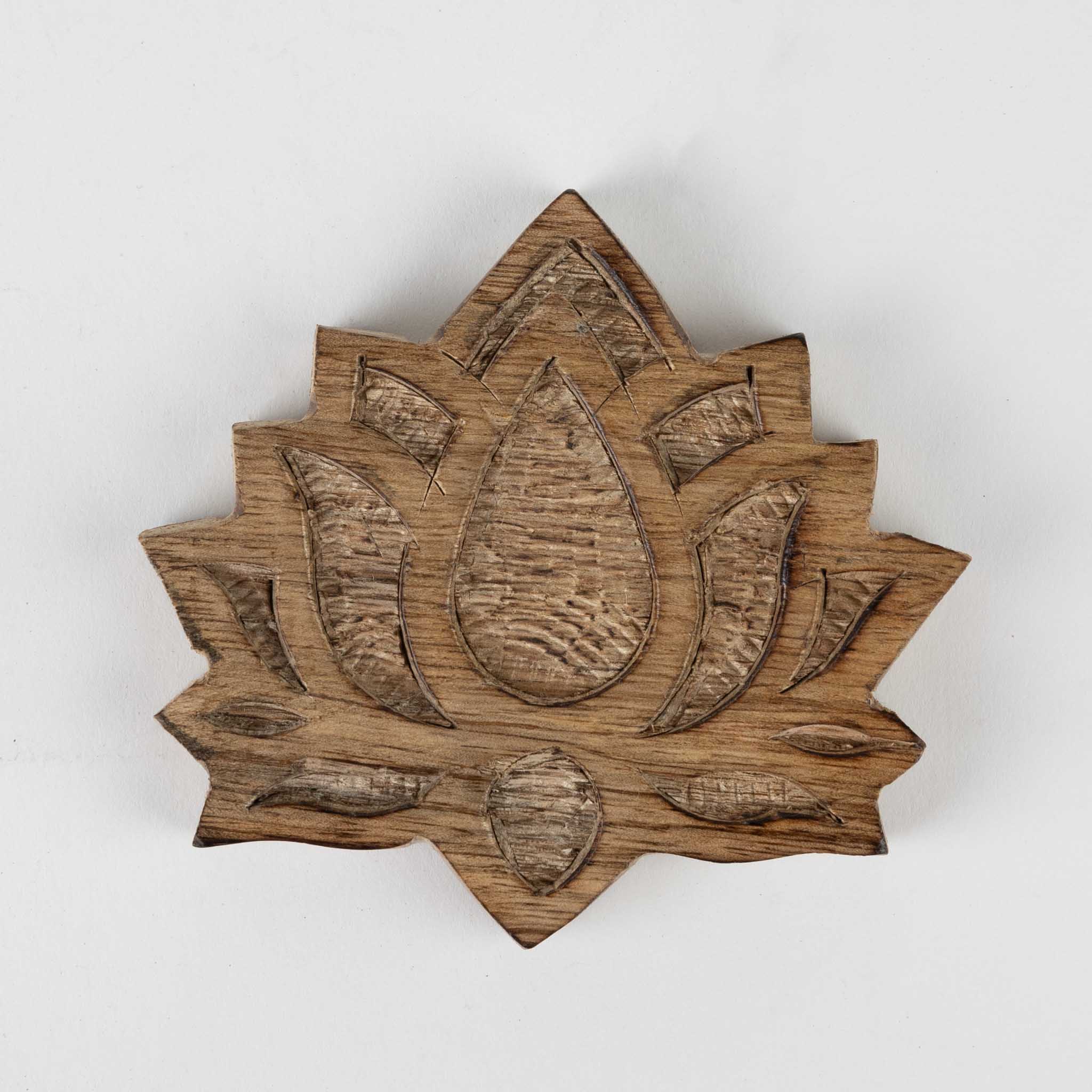 Artisan carving on a handmade wood coaster with natural finish