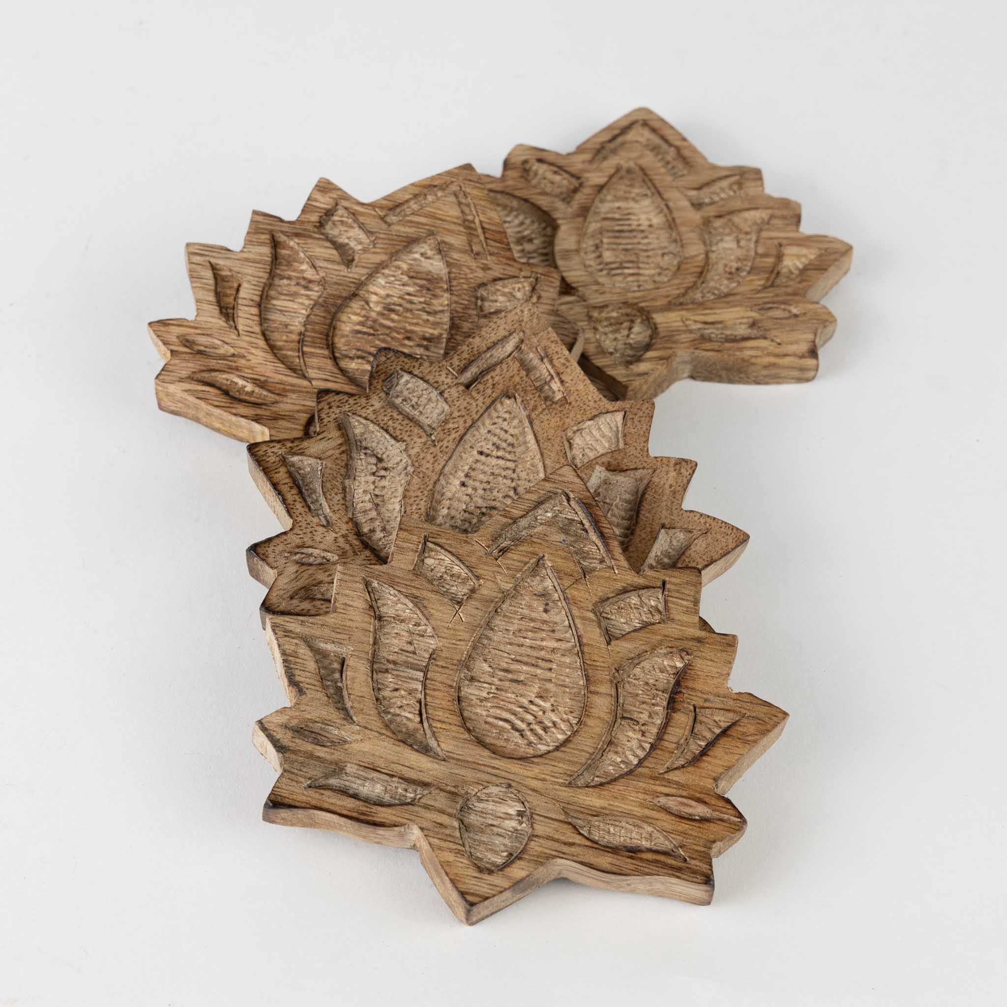 Artisan carving on a handmade wood coaster with natural finish