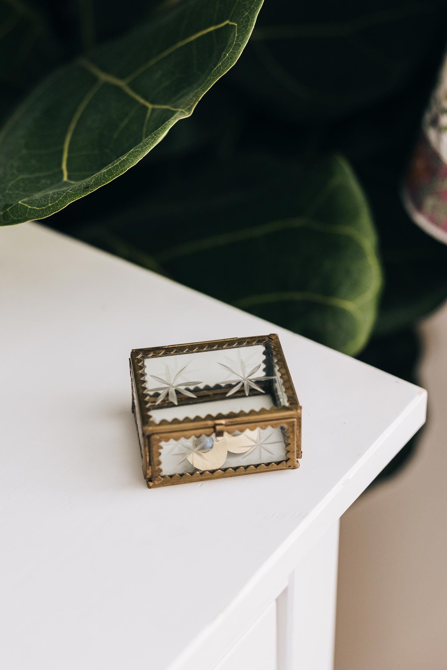 Handcrafted jewelry display box open, revealing organized necklaces and accessories.