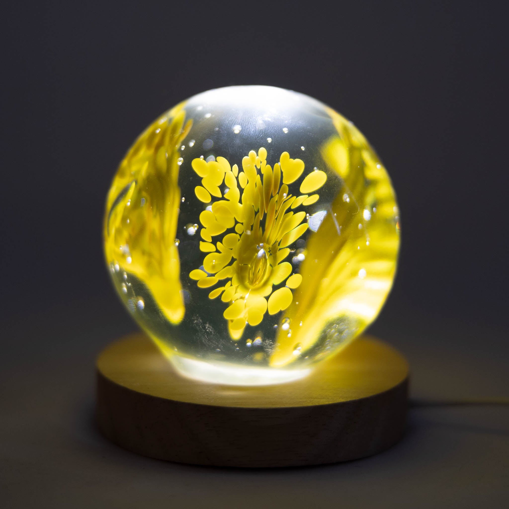Colorful glass paperweight for desk with vivid patterns.