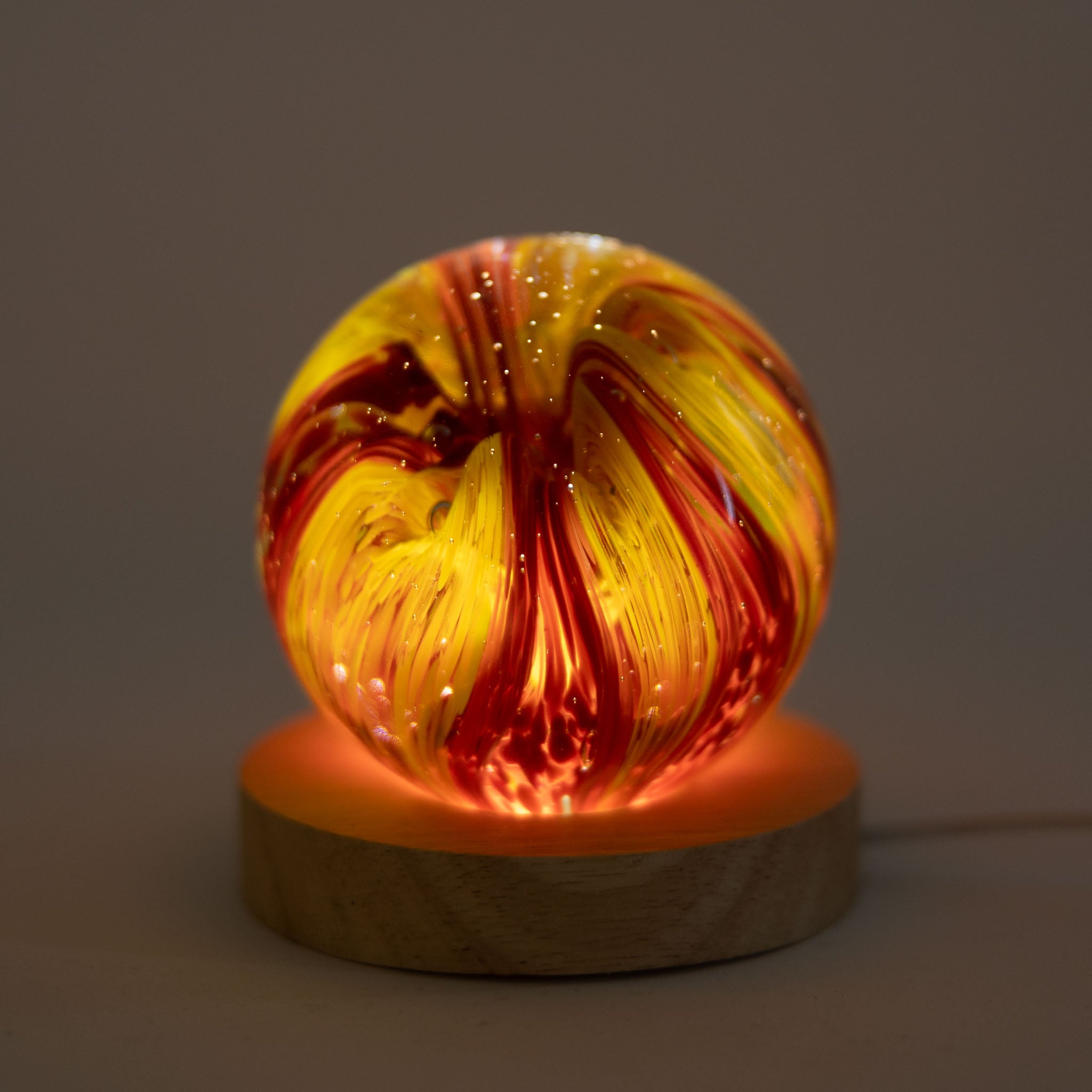 Art glass paperweight displayed on an office desk.