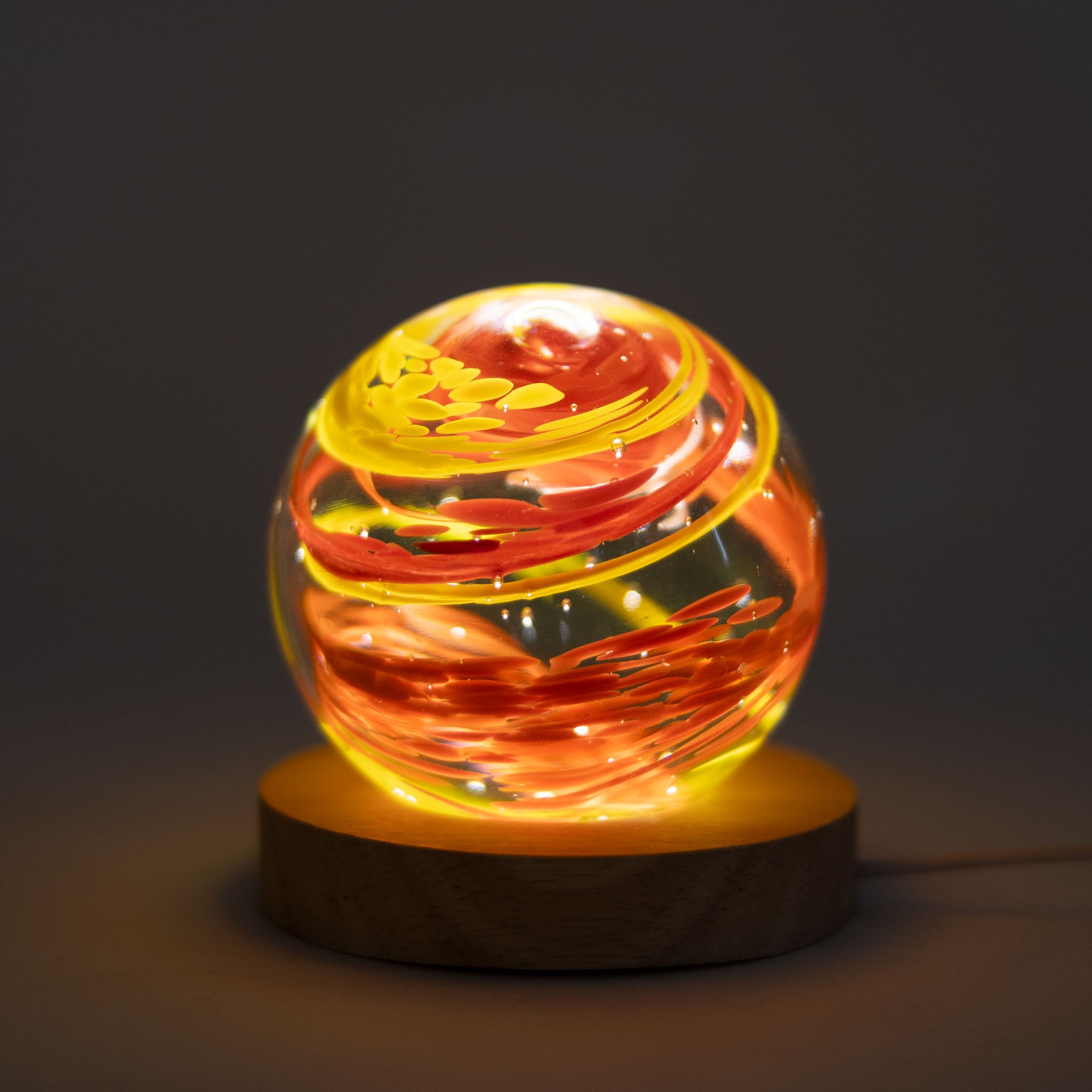 Colorful glass paperweight for desk with vivid patterns.