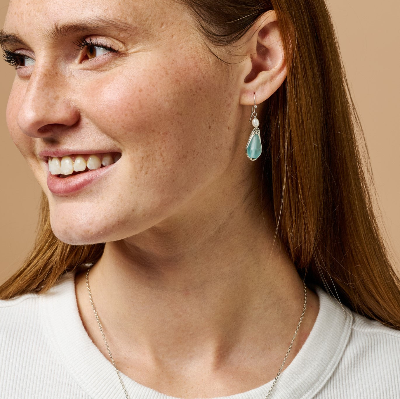 Close-up view of elegant aqua pearl silver drop earrings highlighting the frosted aqua glass bead and pearl accent.