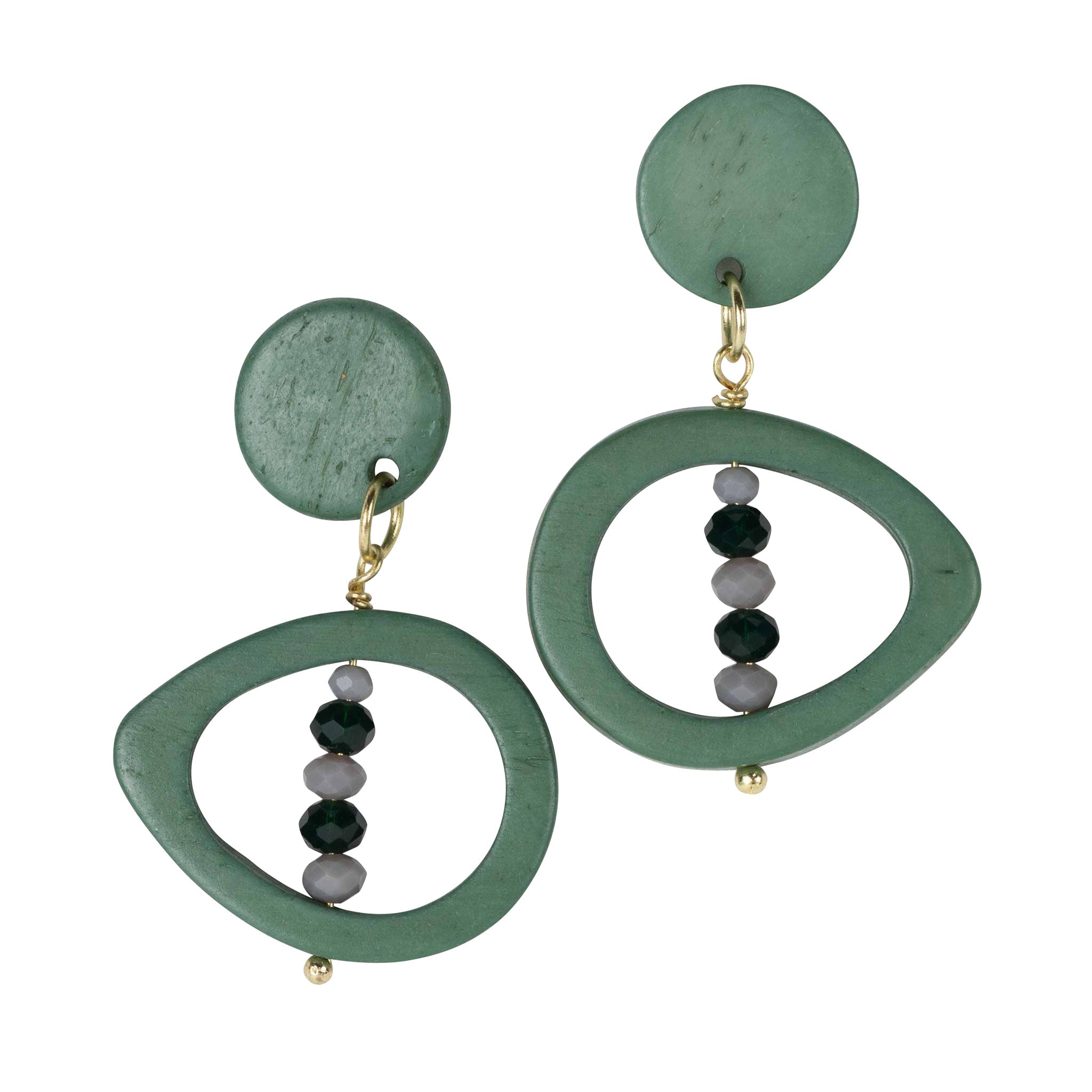 Close-up of handcarved green eyes on bone earrings with glass beads, artisan jewelry for women
