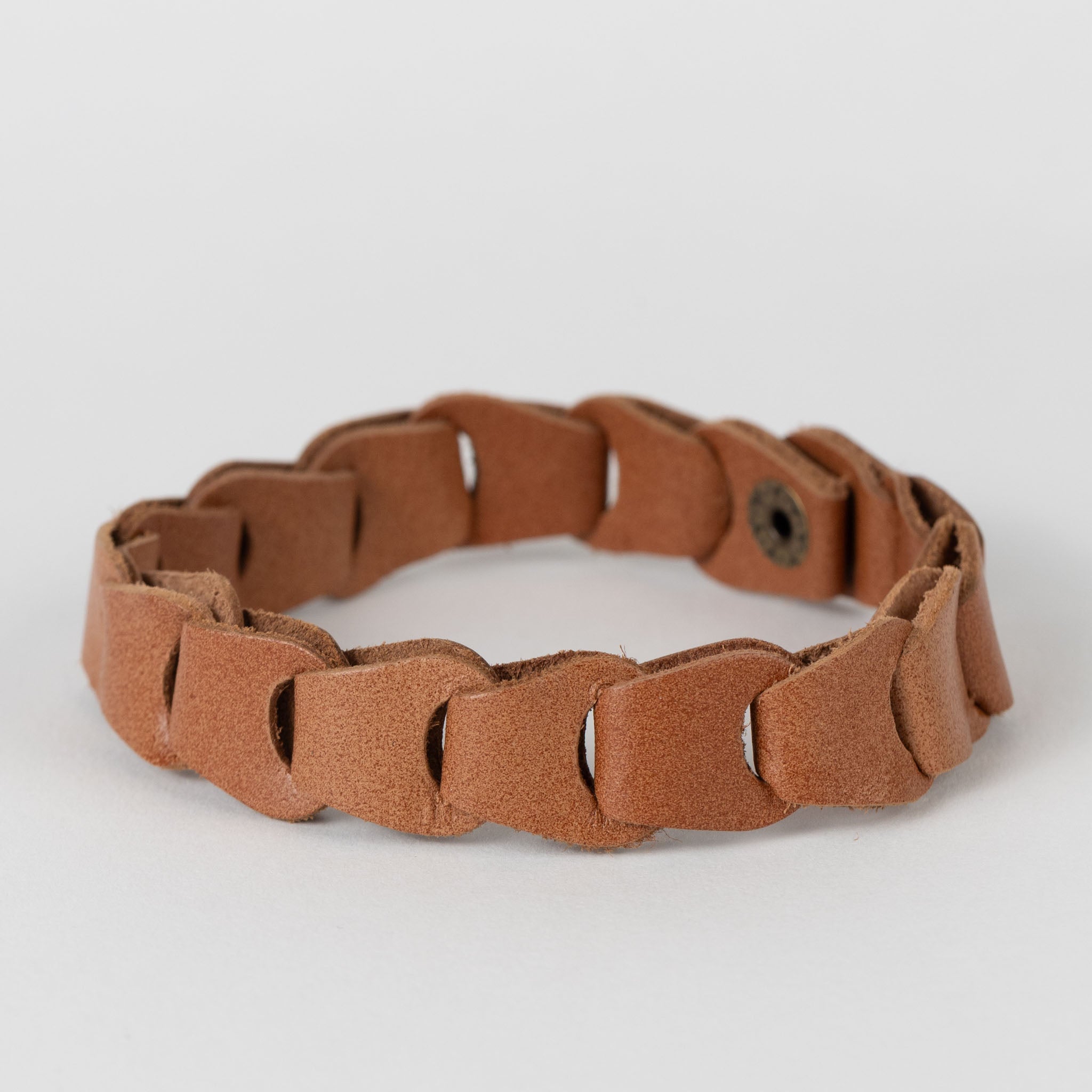 Handcrafted buffalo leather cuff bracelet worn by a man, showcasing its durability and craftsmanship.