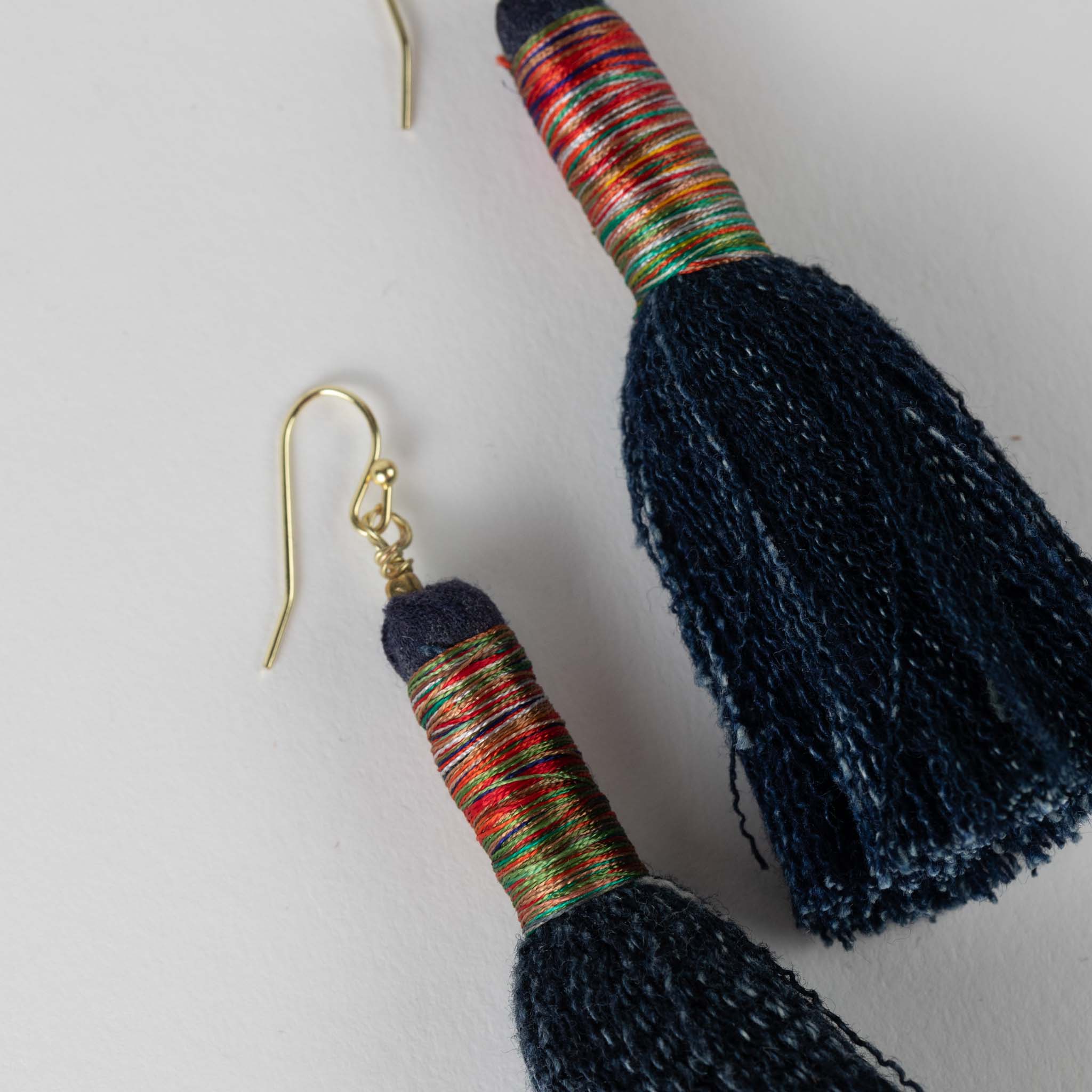 Close-up of handcrafted denim tassel earrings perfect for summer outings
